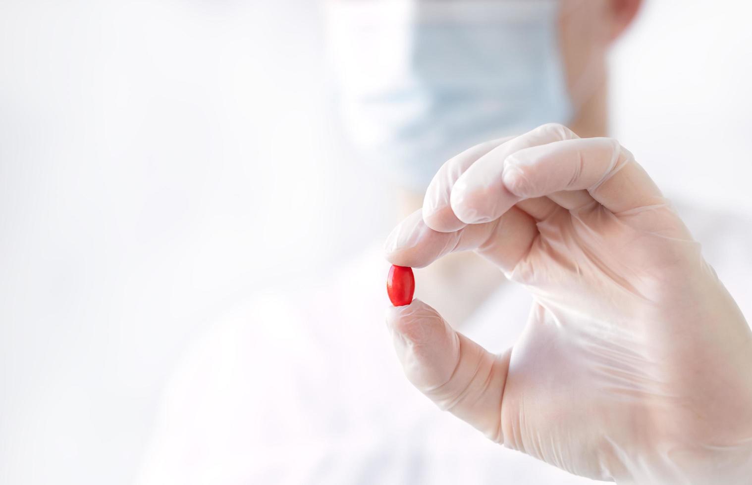 rote Pille in der Hand des Arztes foto