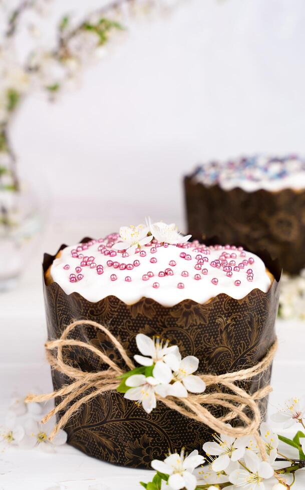 Ostern Kuchen dekoriert mit Weiß Glasur und ein Zweig von Kirsche blüht. Christian Traditionen. Nahansicht. selektiv Fokus. foto