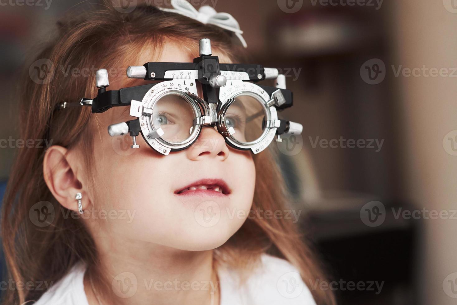 Nahaufnahme des Porträts des Kindes in einer speziellen Brille, die nach rechts guckt foto