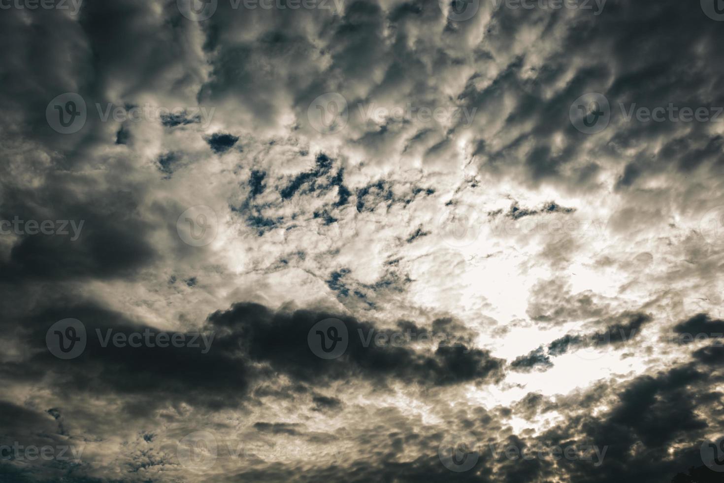 schwarze Gewitterwolken verdunkeln das Licht der Sonne. foto