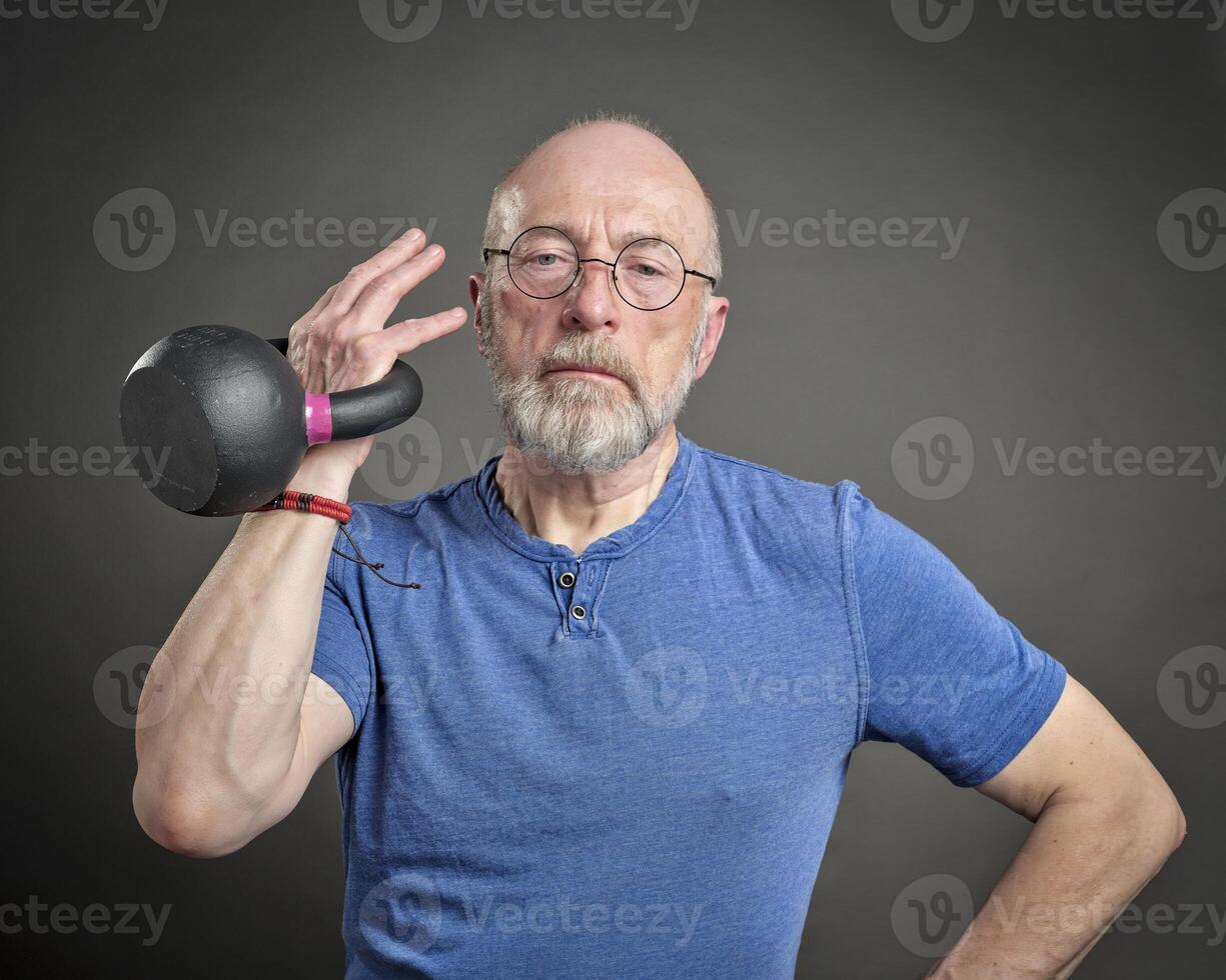 Senior Mann ausüben mit Eisen Kettlebell foto