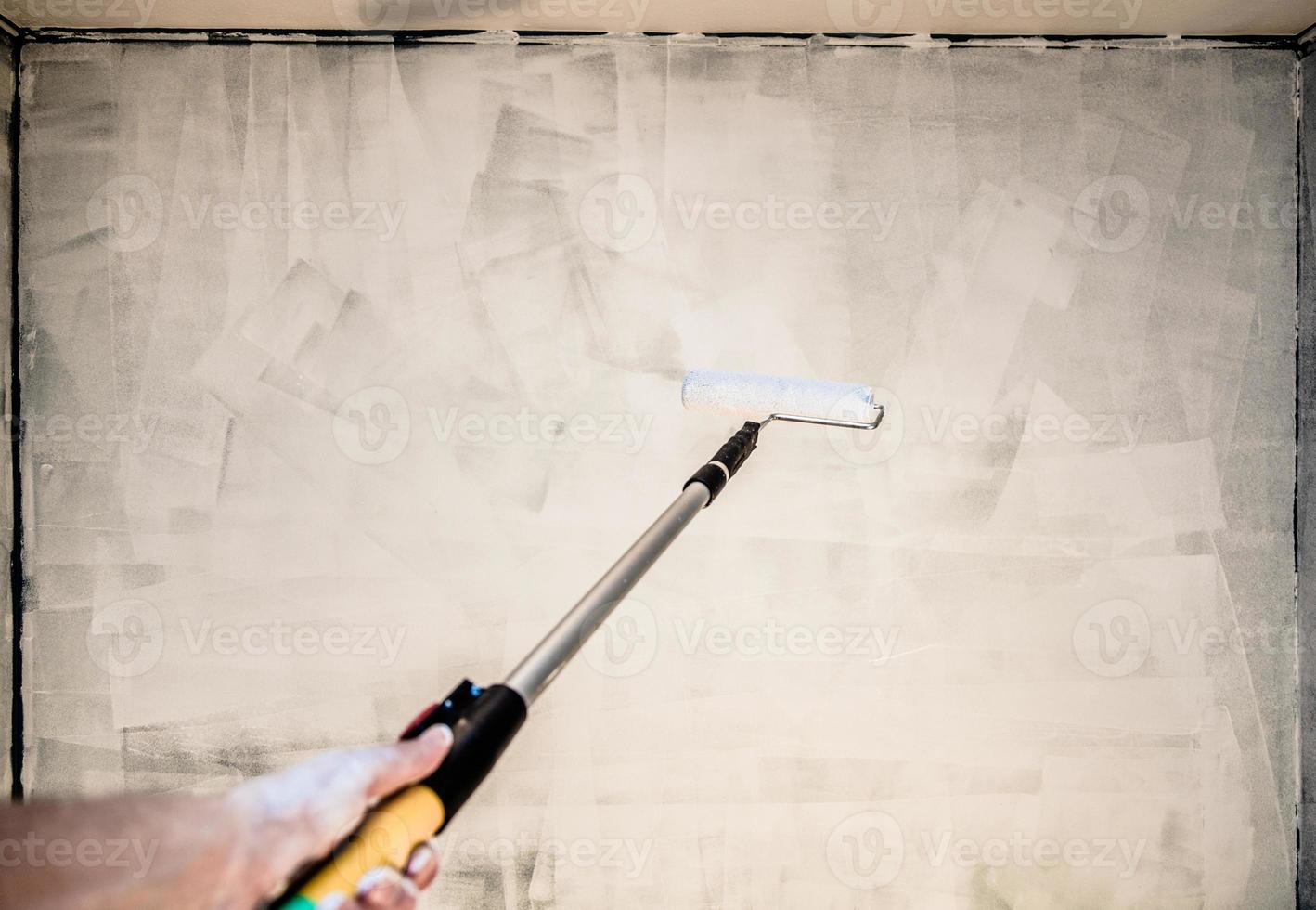 pov von jemandem, der die wand streicht foto