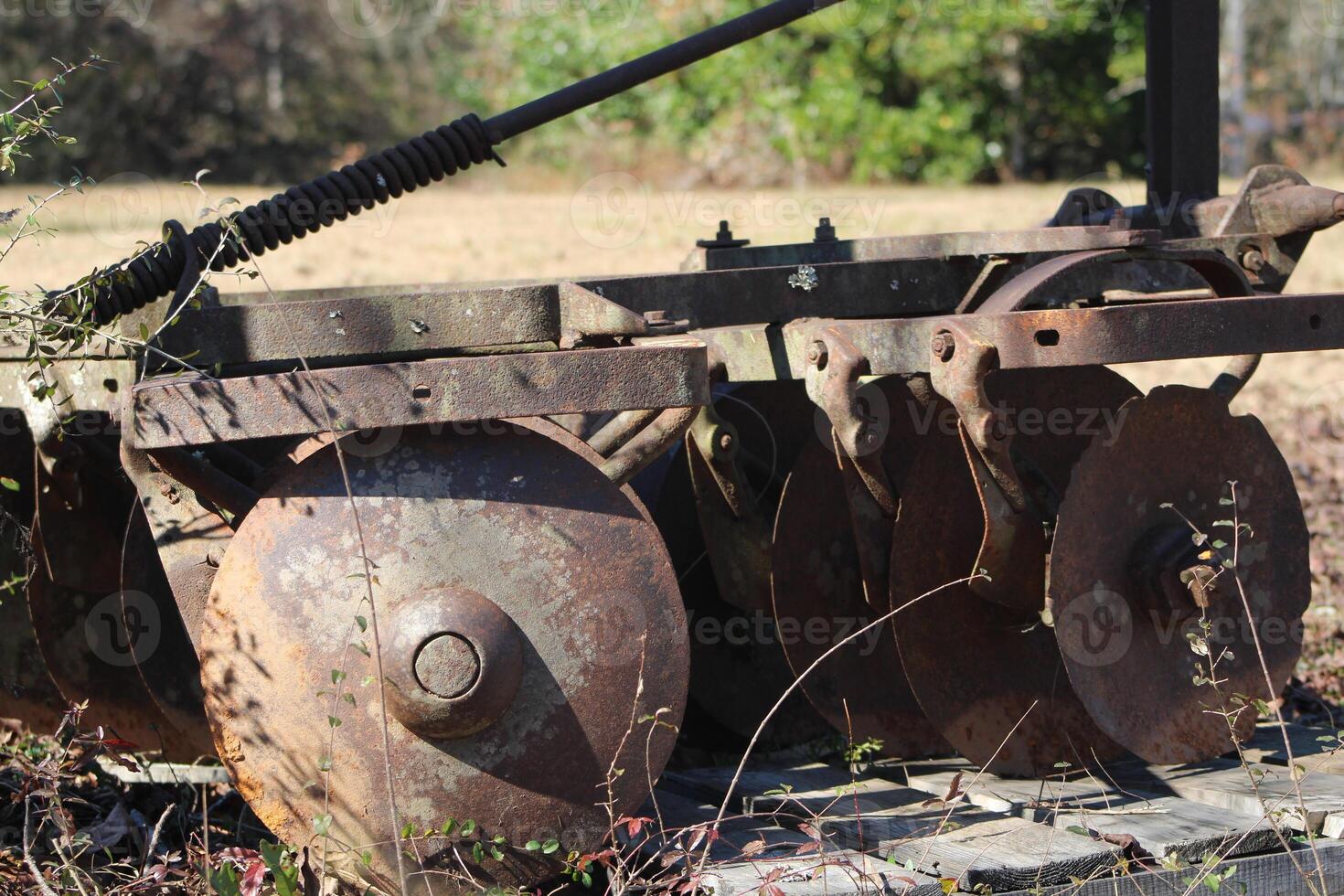 Traktor mit Ausrüstung Sitzung im ein Wiese. foto