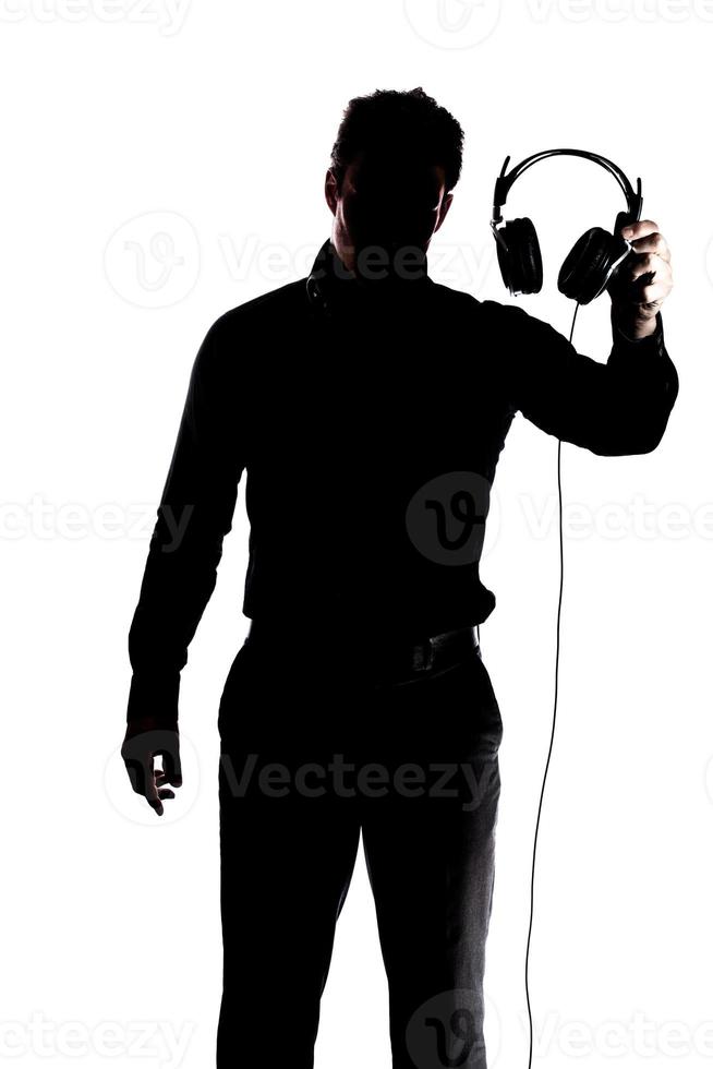 Mann in der Silhouette mit Kopfhörern foto