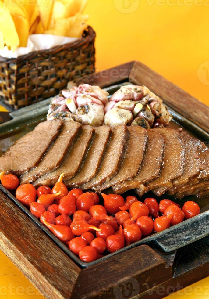 Carne de Sol, typisch nordöstlich Brasilianer Gericht mit Tomaten und gebraten Maniok foto