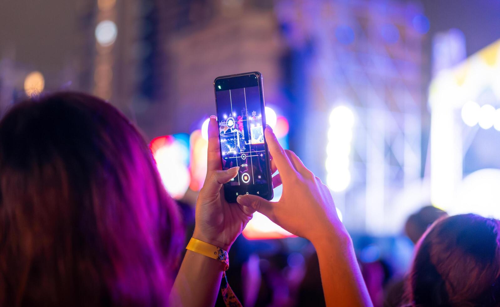 Menschen halten Clever Telefon und Aufzeichnung und Fotografieren im Musik- Festival Konzert foto