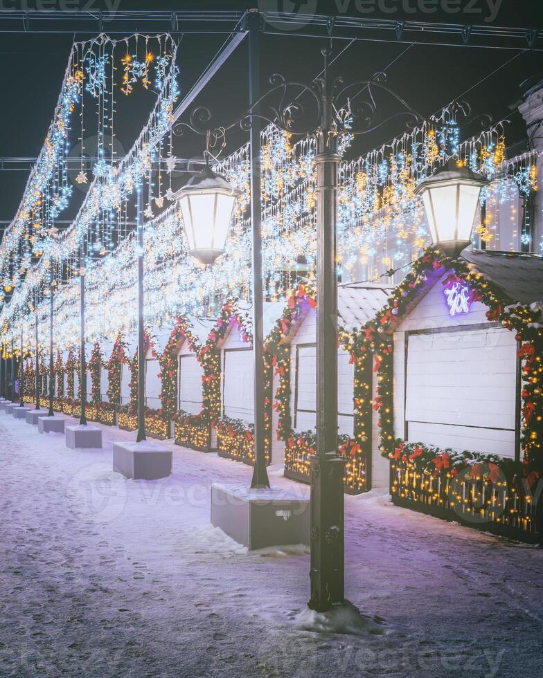 Weihnachten oder Neu Jahre Markt im ein Europa mit Häuser dekoriert mit Spielzeug Bälle und Girlanden beim Nacht. Jahrgang Film ästhetisch. foto