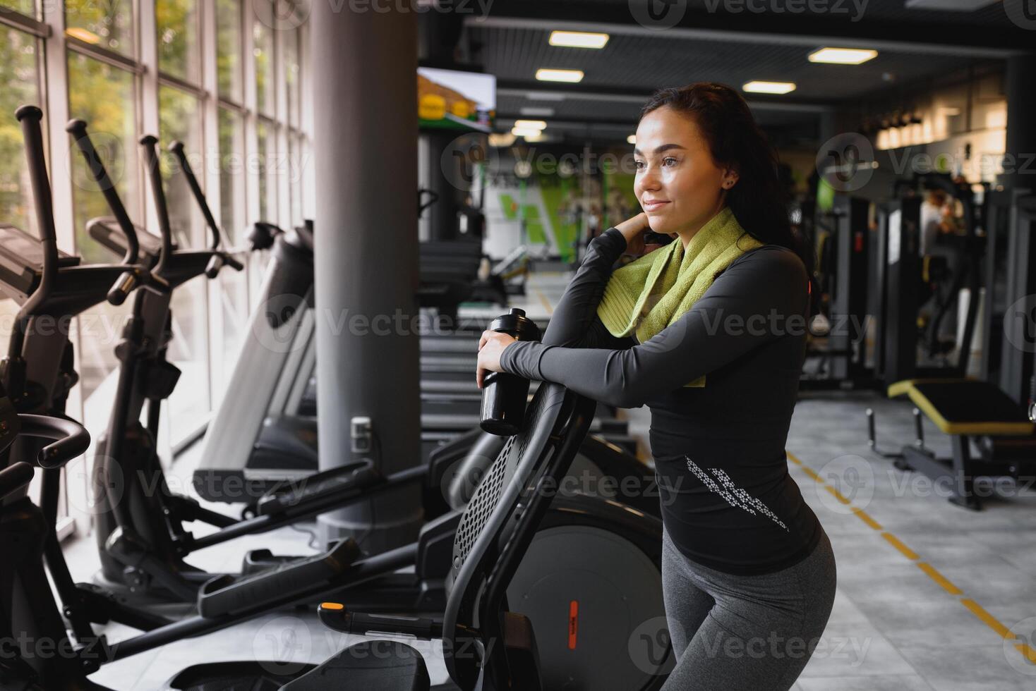jung Frau Trinken Wasser und nehmen ein brechen nach trainieren im Fitnessstudio foto