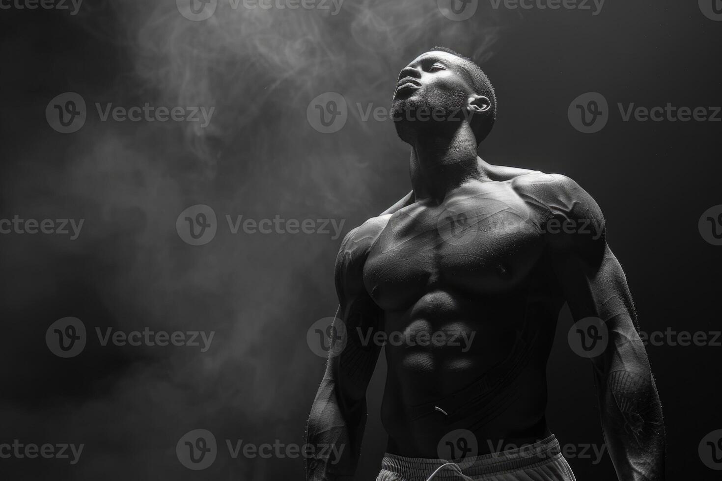 schwarz und Weiß Studio schießen von stark sportlich Mann auf dunkel Hintergrund foto
