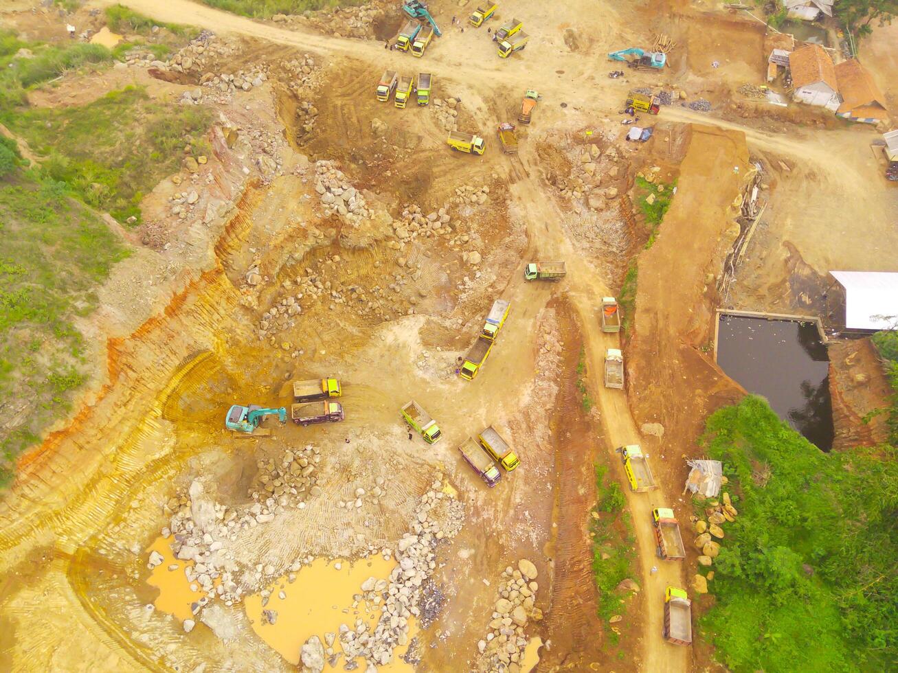 oben Aussicht von LKW Warteschlange. Lastwagen sind Warteschlangen zu Transport Bergbau Produkte von das Stadt von cikancung, Indonesien. Schuss von ein Drohne fliegend 200 Meter hoch foto