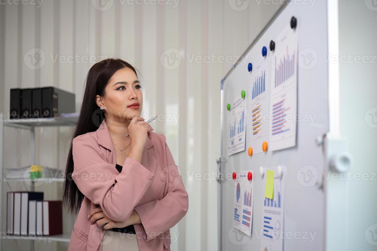 asiatisch Geschäftsfrau oder weiblich finanziell Analytiker finanziell Analyse und Investition planen auf ein Tafel beim Büro foto