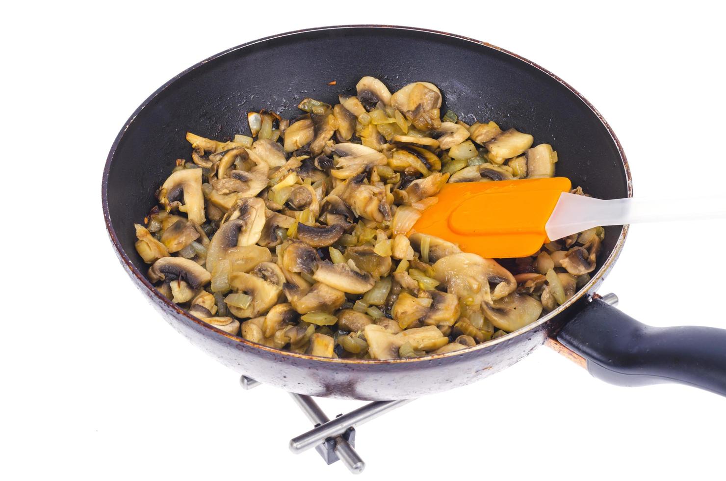 Pfanne mit gebratenen Champignons auf weißem Teller. Studiofoto foto