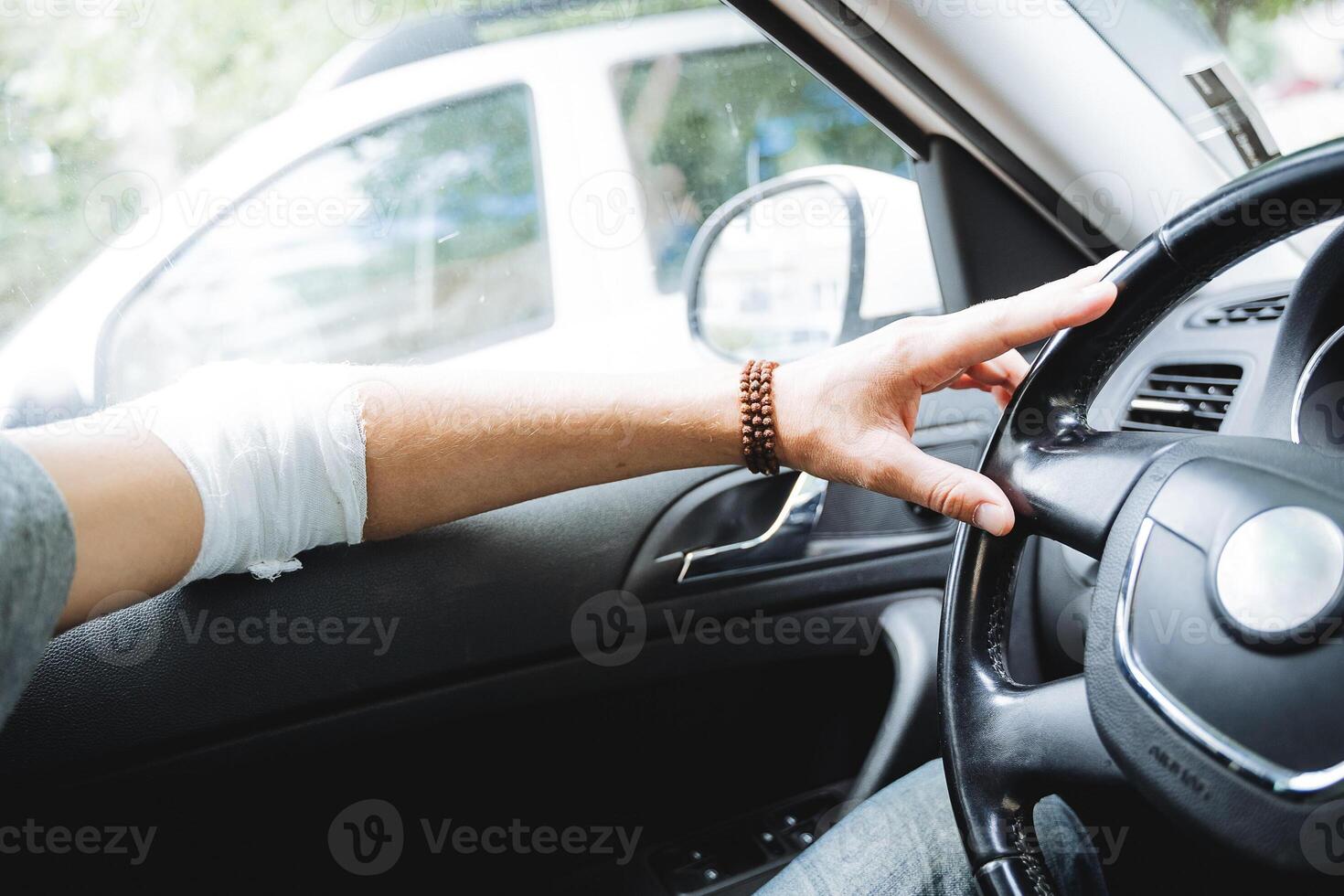 zu Fahrt ein Auto mit ein verletzt Hand, ein verbunden Ellbogen Arm tut weh, ein Straße Verletzung, ein Person sitzt Innerhalb das Auto, ausgerenkt Ellbogen. foto