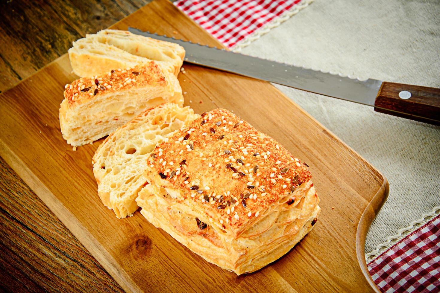 geschnittenes Brot mit Sesam auf einem Holzbrett foto