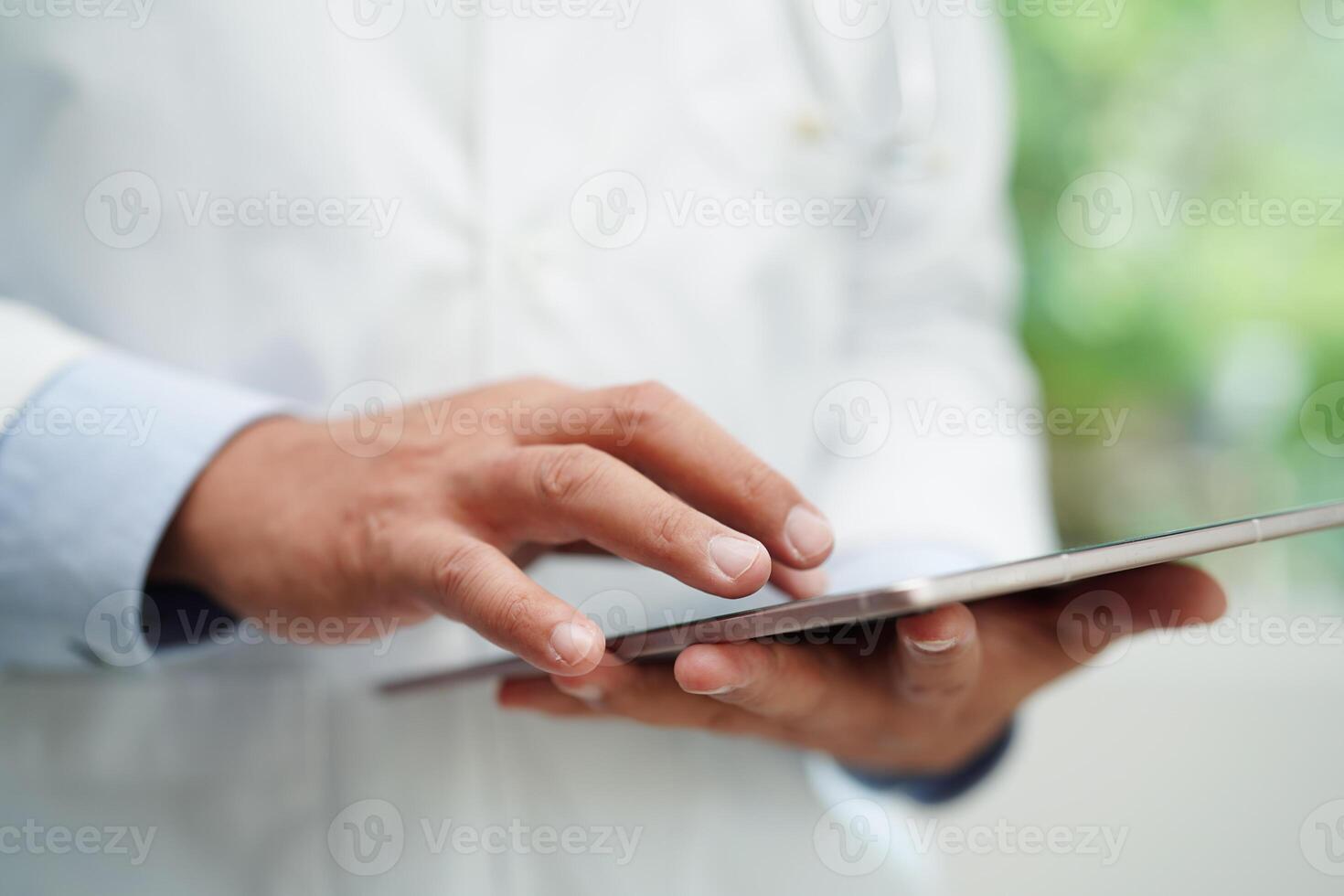 asiatisch Mann Arzt mit Tablette Computer zu lesen geduldig Bericht, prüfen oben und Suche zum lösen Behandlung Gesundheit medizinisch online im Krankenhaus. foto