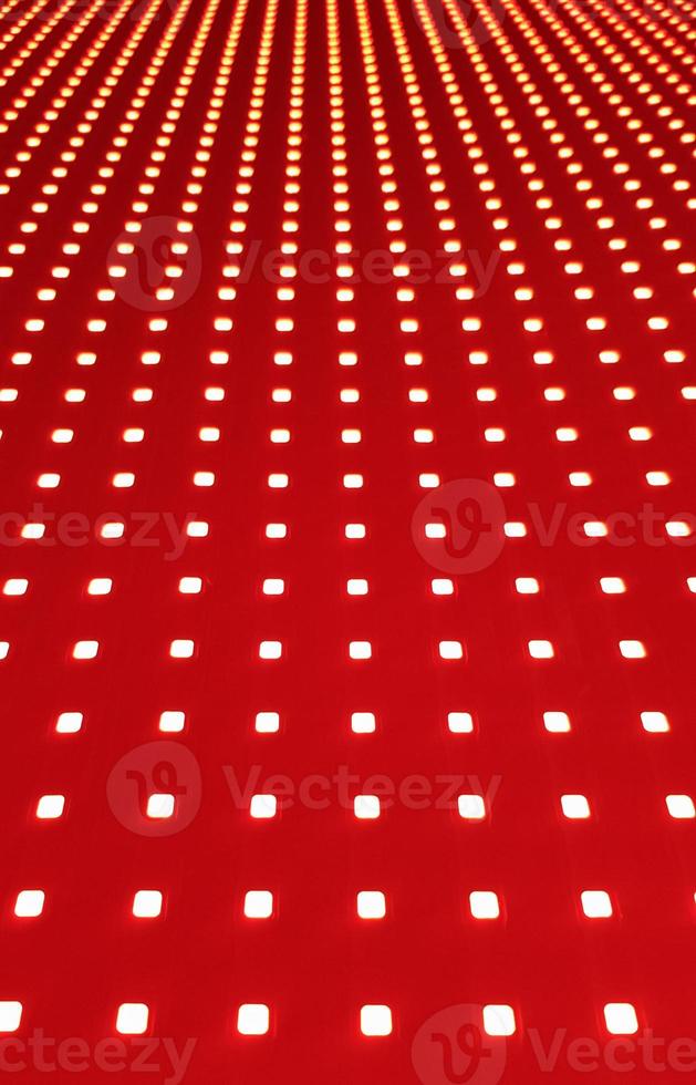 RGB-LED-Bildschirm-Panel-Textur. Nahaufnahme eines Pixel-LED-Bildschirms mit Bokeh für Tapeten. leuchtend roter abstrakter Hintergrund perfekt für jedes Design. foto