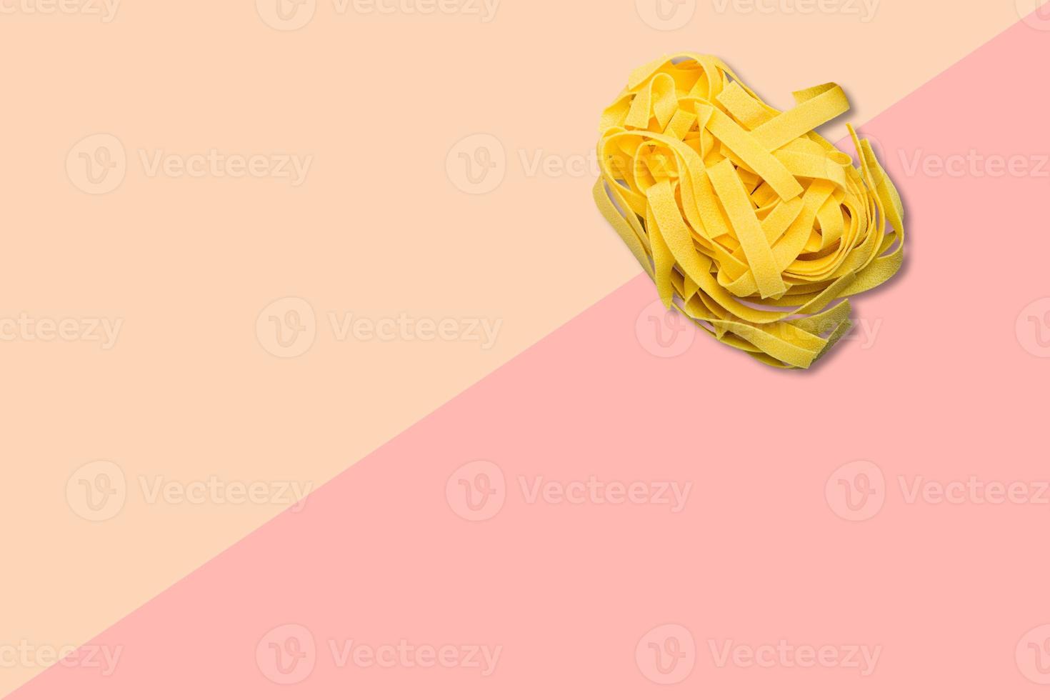 Nahaufnahme italienische rohe Spaghetti auf rosa Hintergrund isoliert. foto