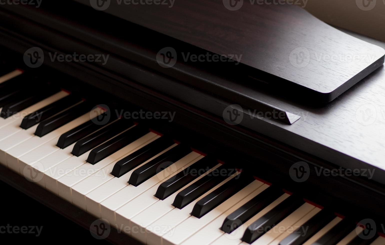 Klavier und elektronische Klaviertastatur mit schwarzem Hintergrund. Nahaufnahme von schwarzen und weißen Klaviertasten, Textfreiraum, Banner foto