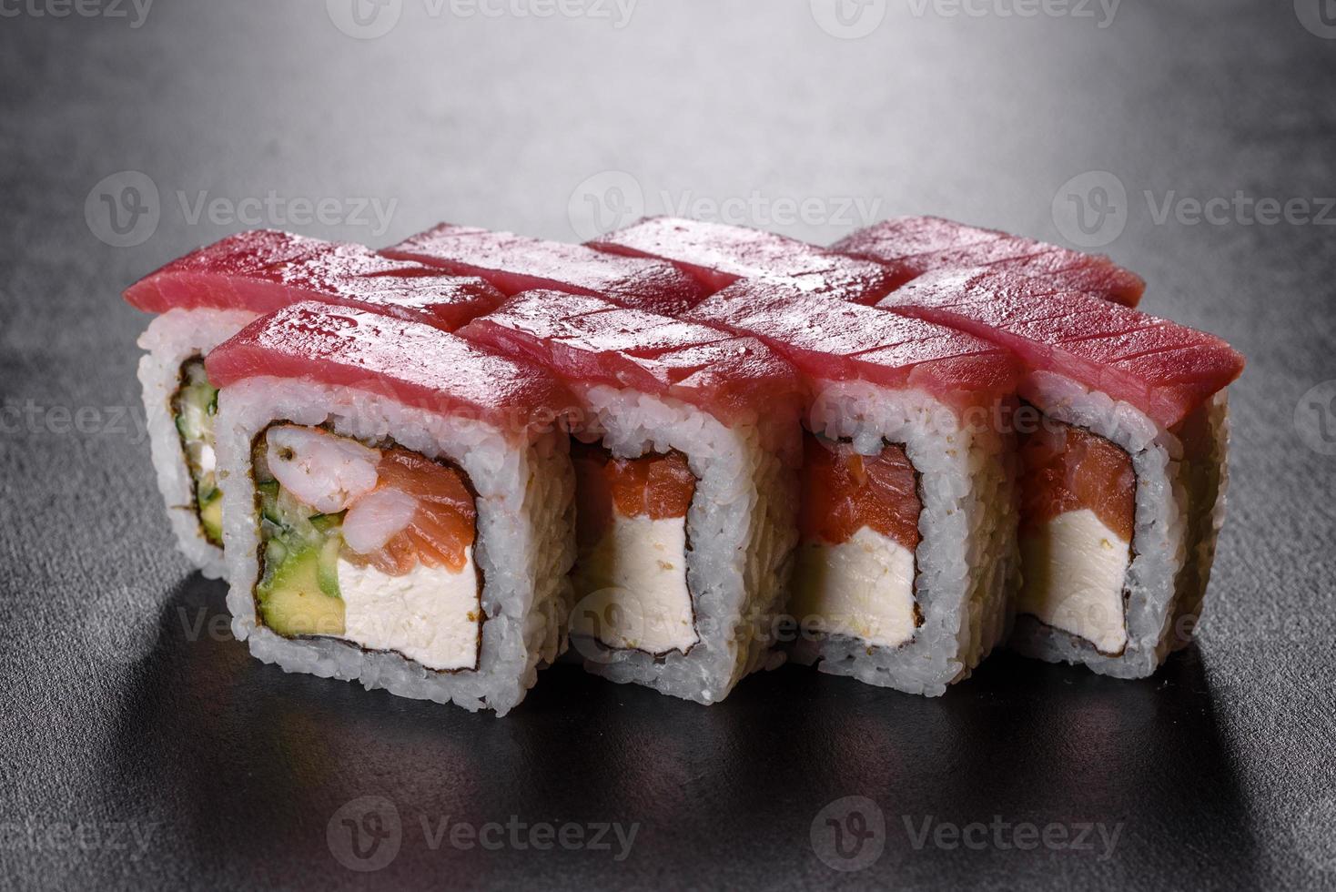 traditionelle köstliche frische Sushi-Rolle auf schwarzem Hintergrund foto