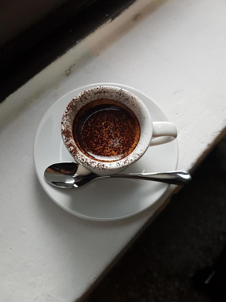 Milchkaffee mit Schokopulver drauf in der Tasse foto