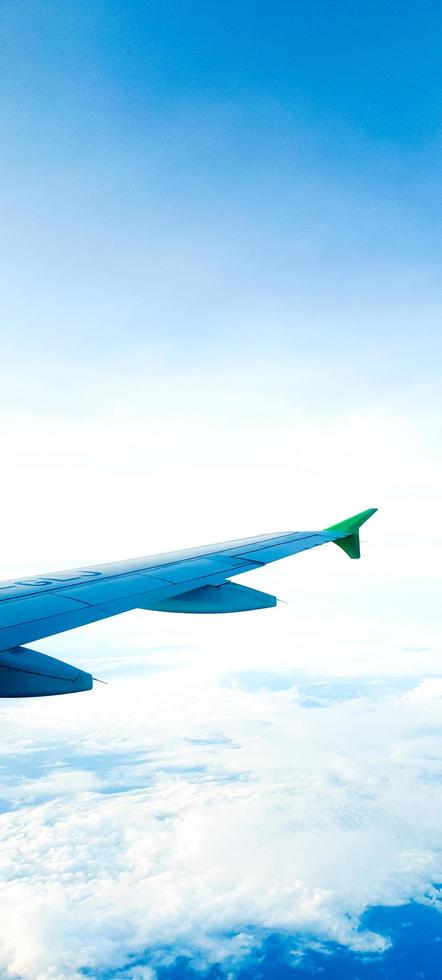 ein Flügel eines Flugzeugs. eine schöne Aussicht auf den Himmel aus der Flugzeugperspektive. faszinierende weiße Wolken am Himmel. was Sie beim Fliegen sehen werden. Schönheit der Stratosphäre. foto