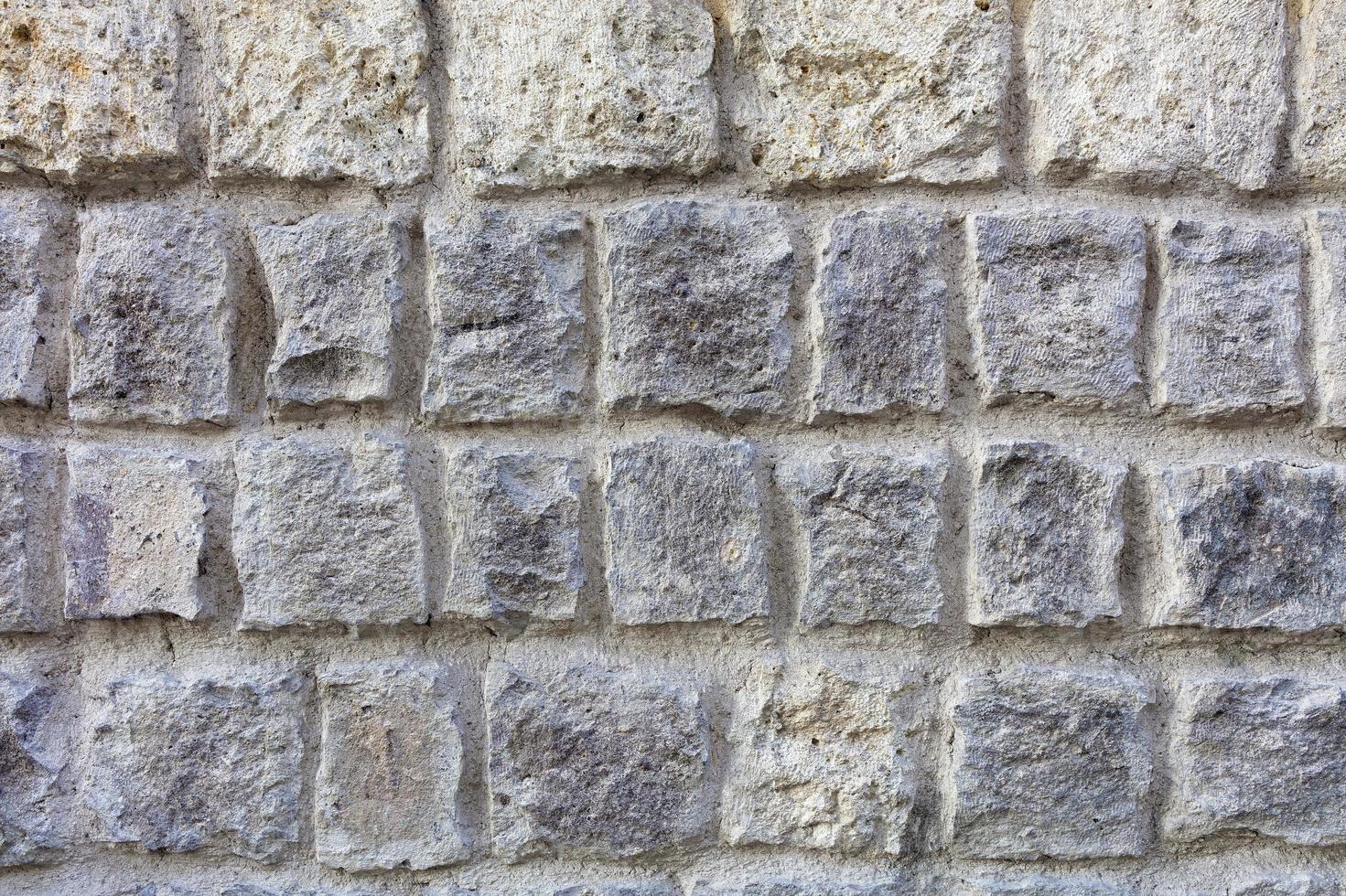 Steinmauer aus einer großen Kopfsteinpflaster-Sandstein-Nahaufnahme foto