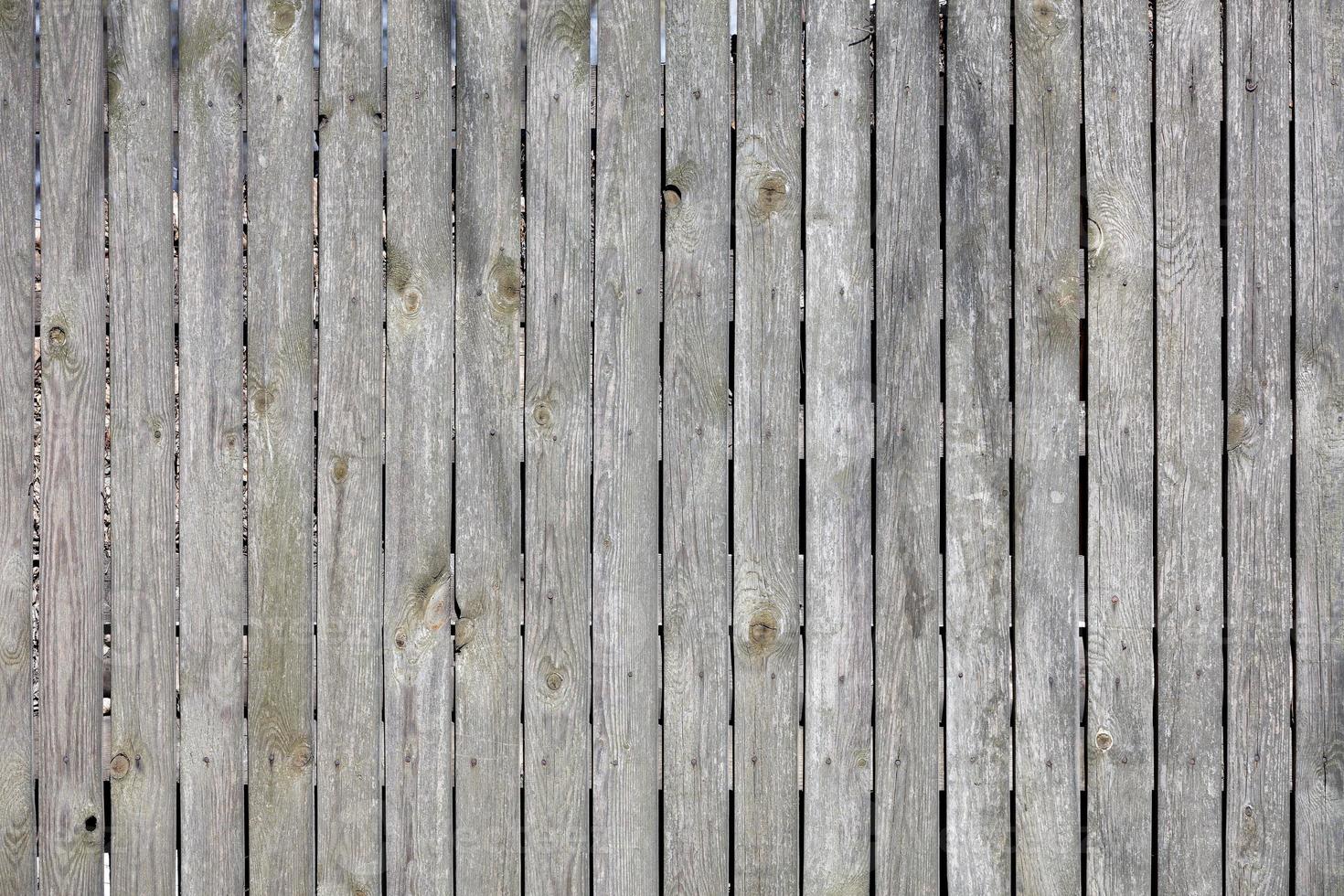 Textur und Hintergrund eines alten grauen Holzzauns mit verwittertem Holz. foto