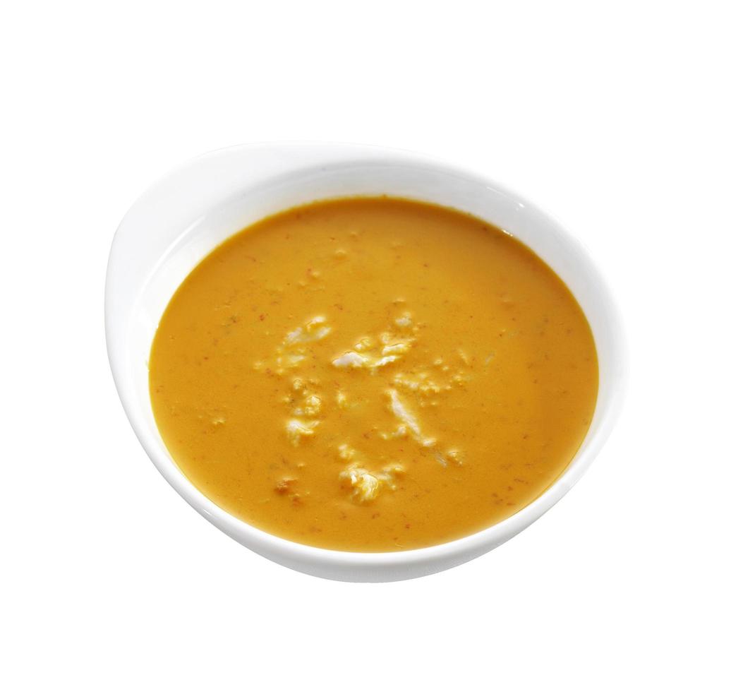 rotes Curry in Keramiktasse auf weißem Hintergrund foto