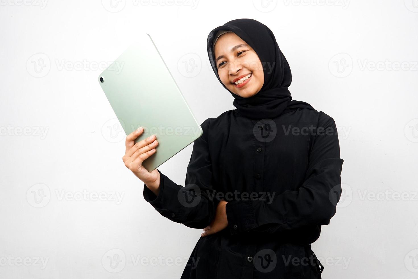 schöne junge asiatische muslimische Frau lächelnd, aufgeregt und fröhlich mit Tablet, isoliert auf weißem Hintergrund foto