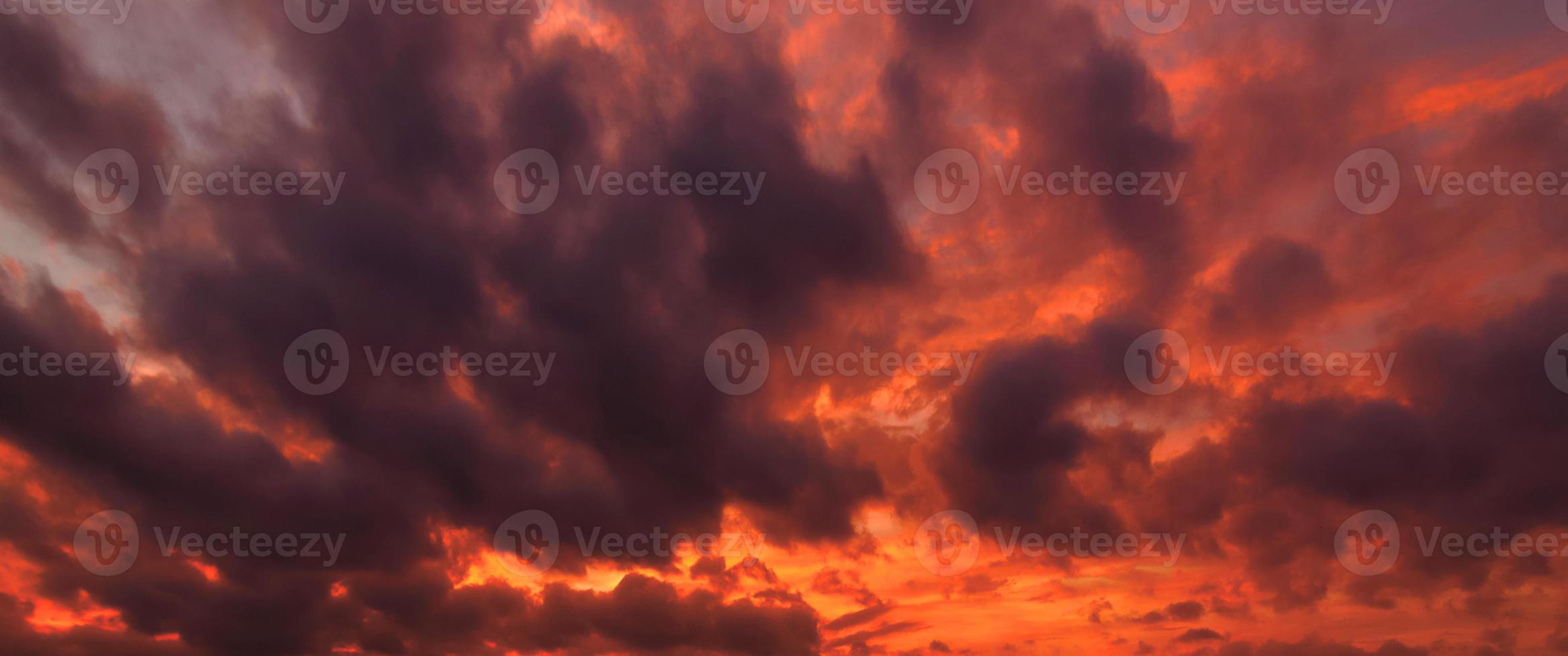 Orange und graue Wolken schönes Sonnenuntergangsambiente mit großer gelber und orangefarbener Sonne in den Himmelsoberflächenhügeln. foto