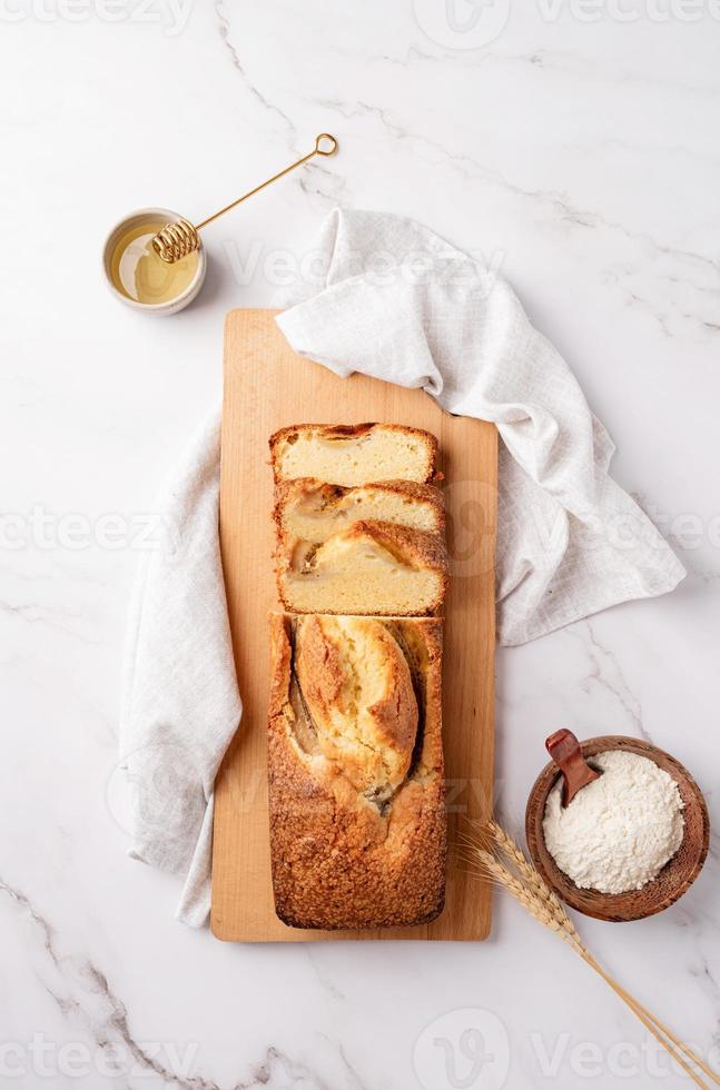 Draufsicht auf geschnittenes Bananenbrot auf hellem Betonhintergrund foto