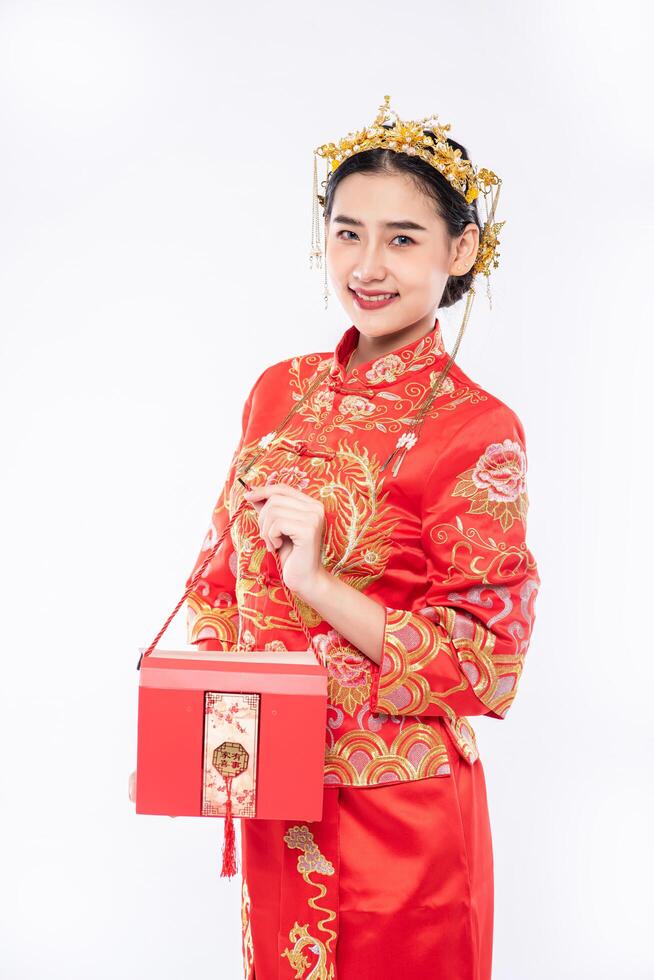 Frau trägt Cheongsam-Anzug Lächeln, um Geschenkgeld vom Chef im chinesischen Neujahr zu bekommen foto