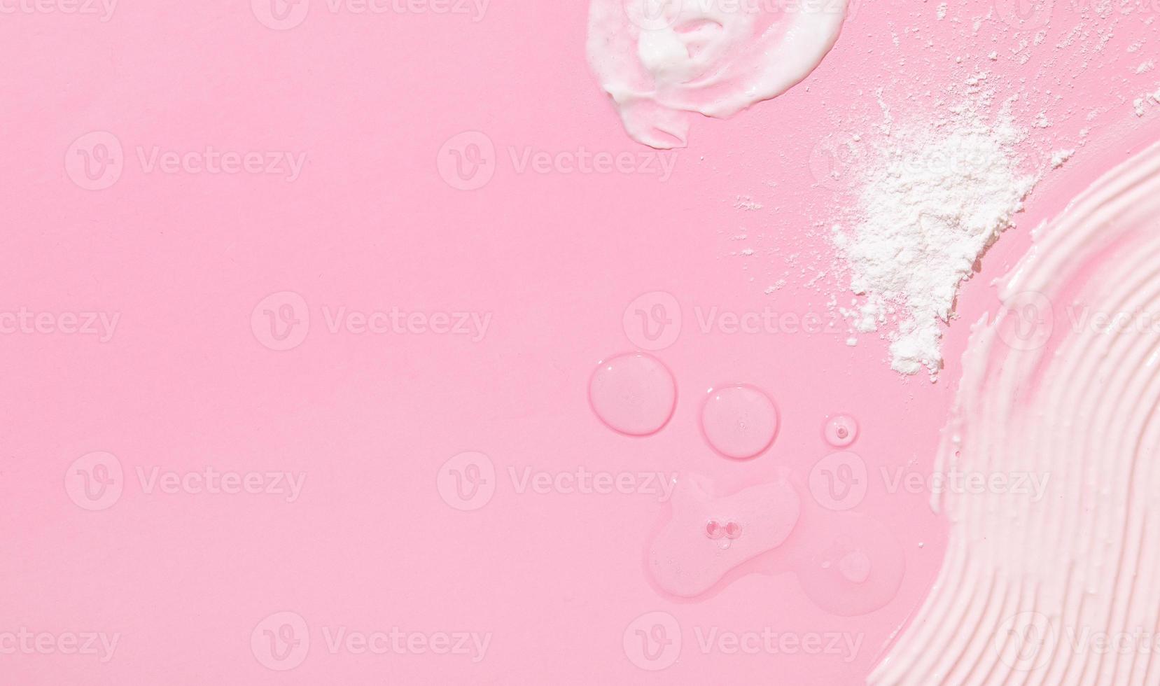 Abstriche und Tropfen verschiedener Kosmetikprodukte und eine Pipette auf rosafarbenem Hintergrund mit Kopierraum foto