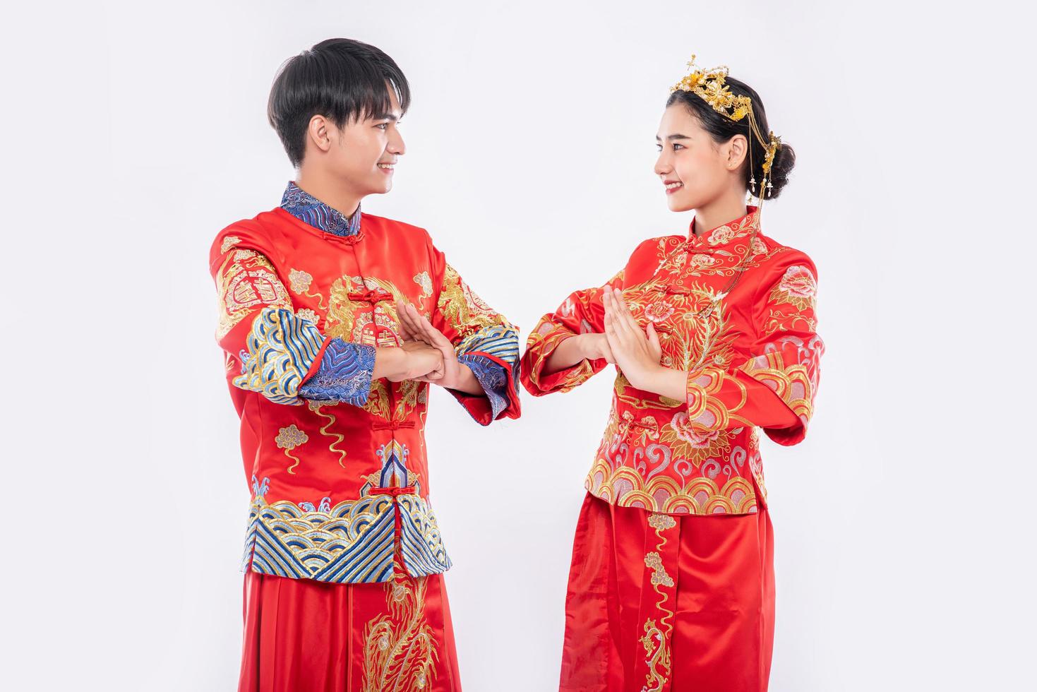 Männer und Frauen tragen Qipao, um ihren Respekt zu erweisen. isoliert auf weißem Hintergrund foto