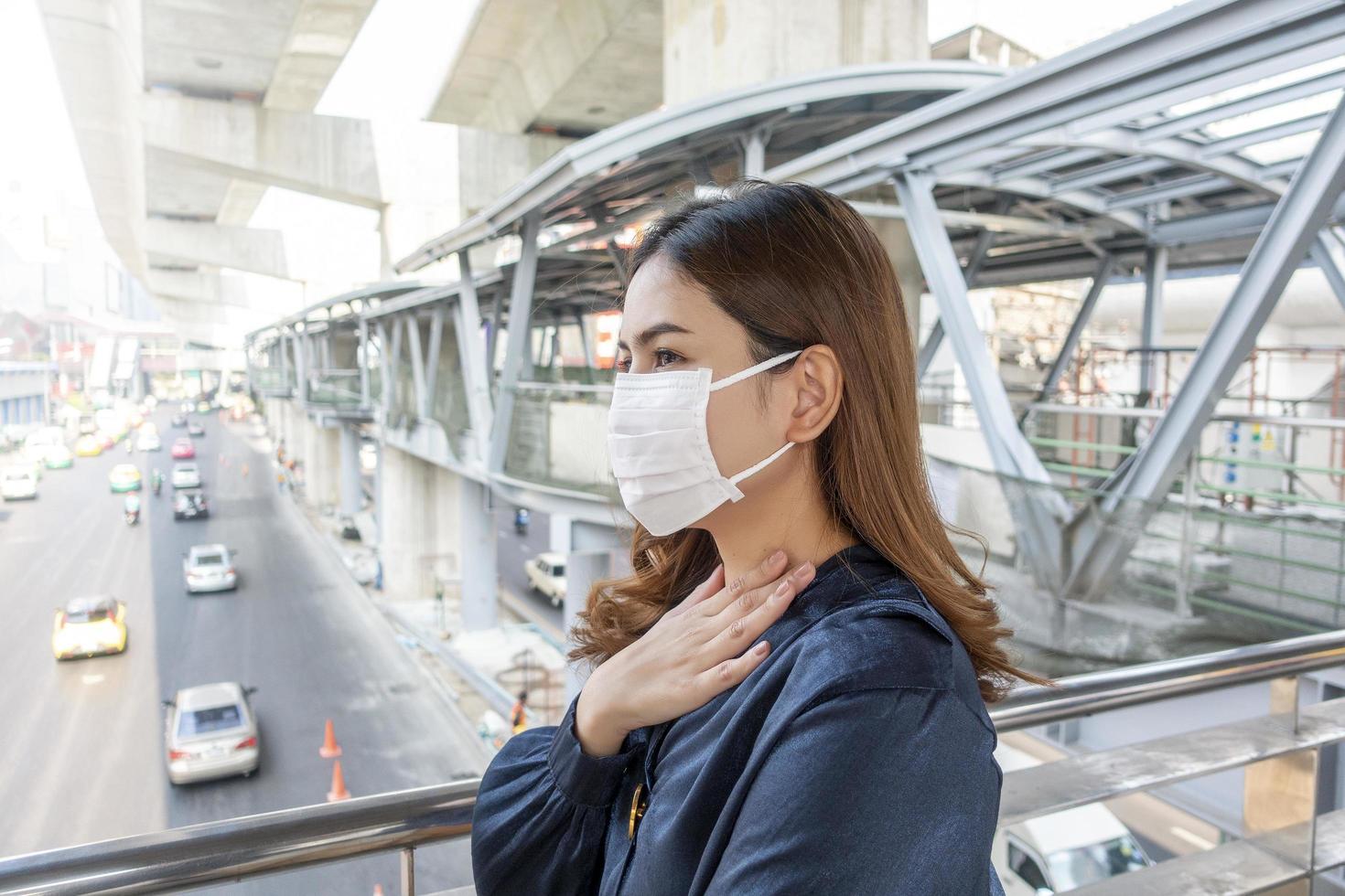 Schöne Frau, die eine Anti-Staub-Maske trägt, schützt die Luftverschmutzung und um 2,5 Uhr auf der Straße foto