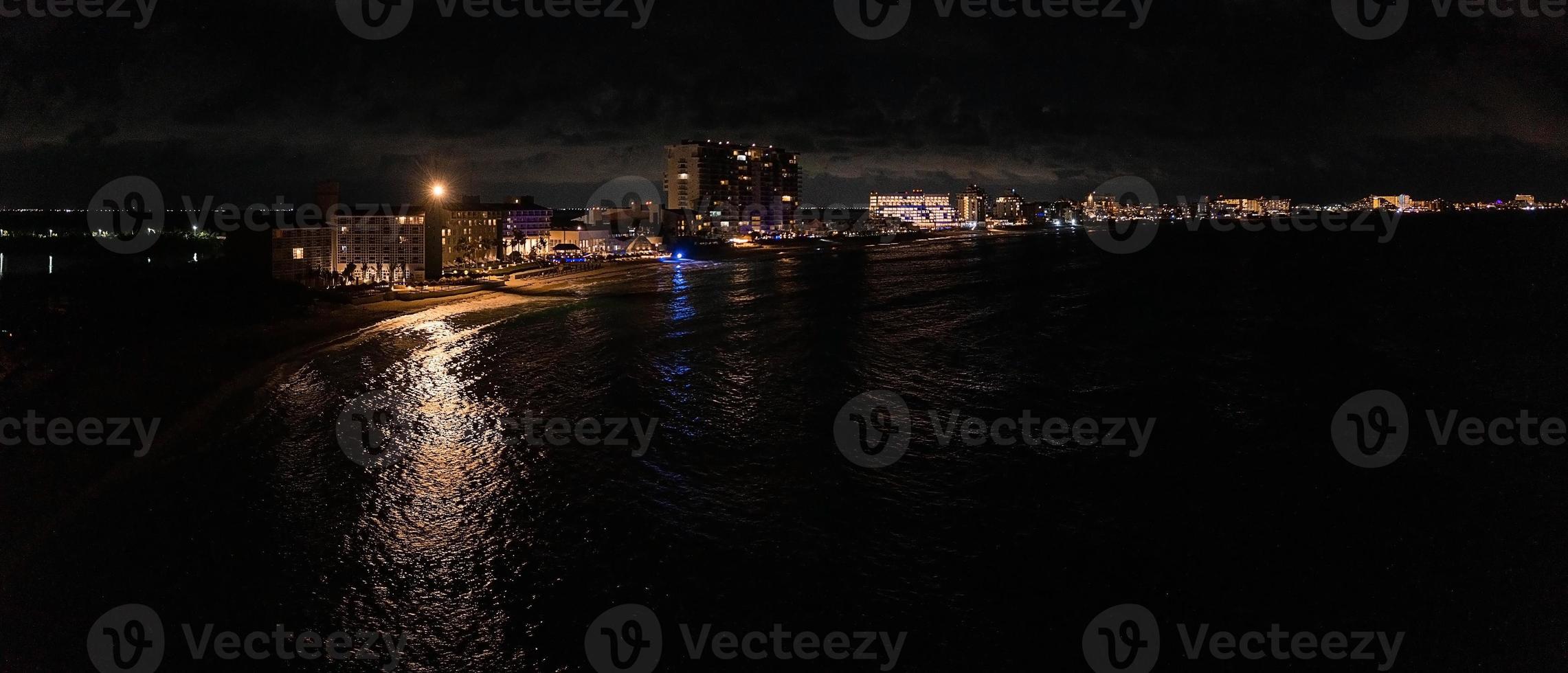Luftaufnahme des Luxushotels bei Nacht am Meer mit riesigem Infinity-Pool. foto