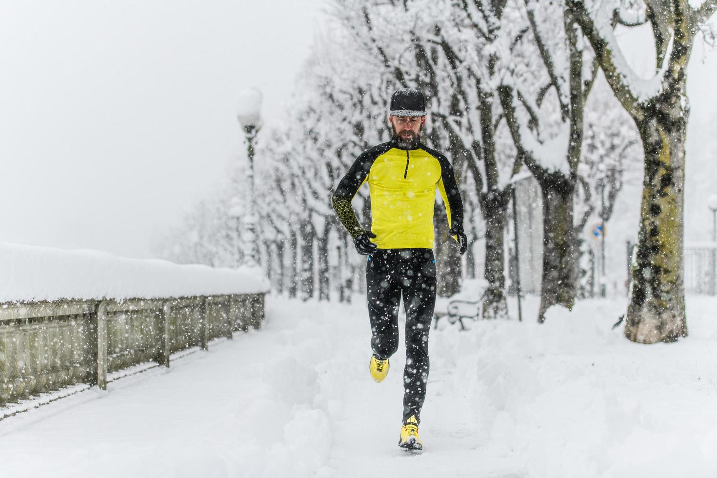 viel Schnee auf den Straßen mit einem Läufer, der trainiert foto