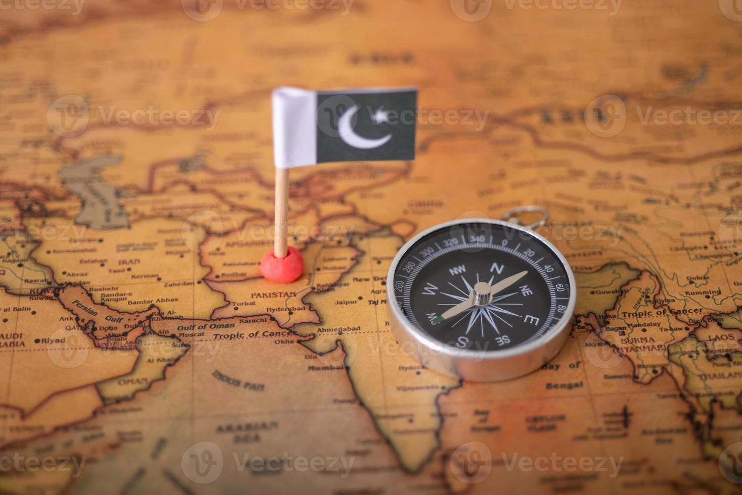 Flagge Pakistans und Kompass auf der Weltkarte. foto