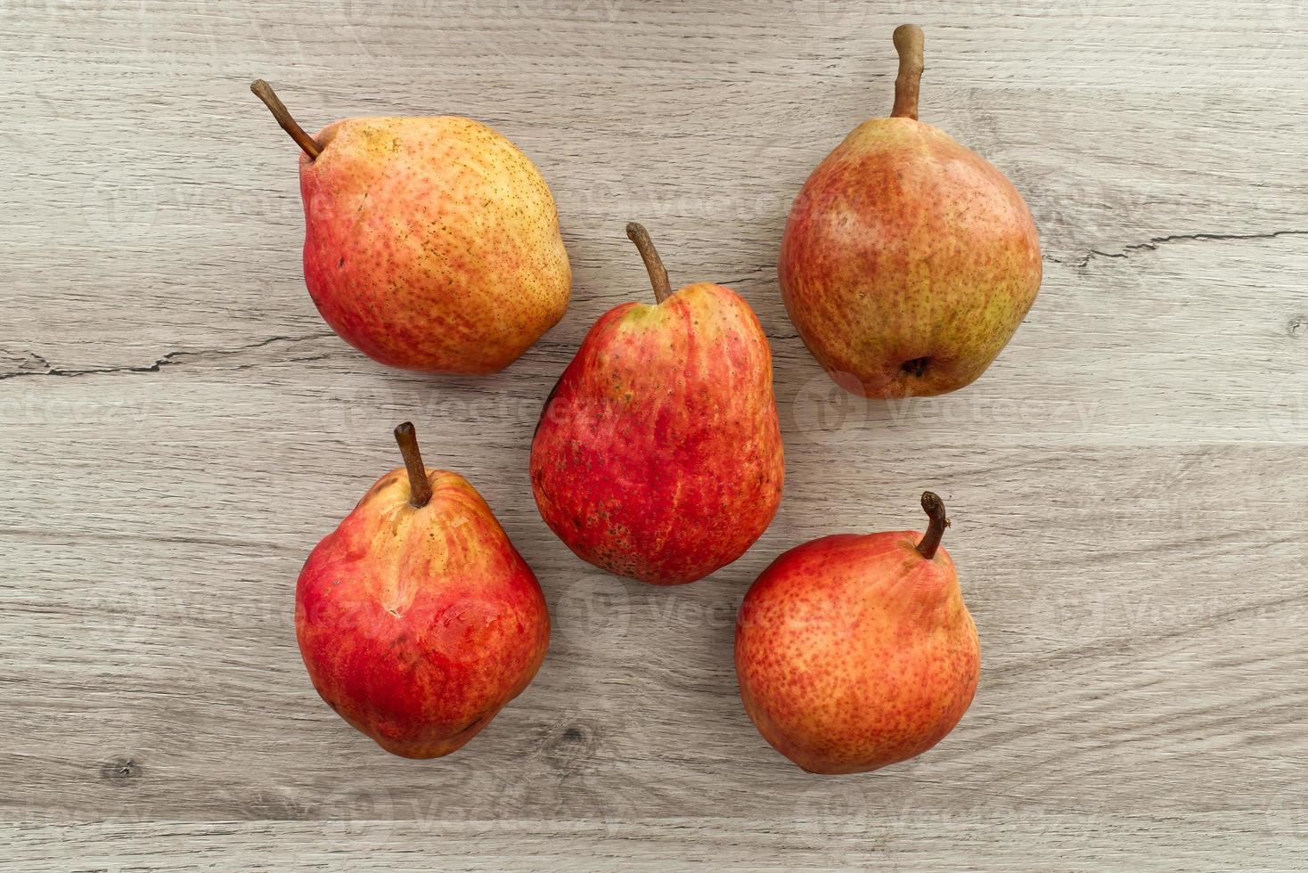 frische rote Birnen isoliert auf Holzhintergrund. Ansicht von oben foto