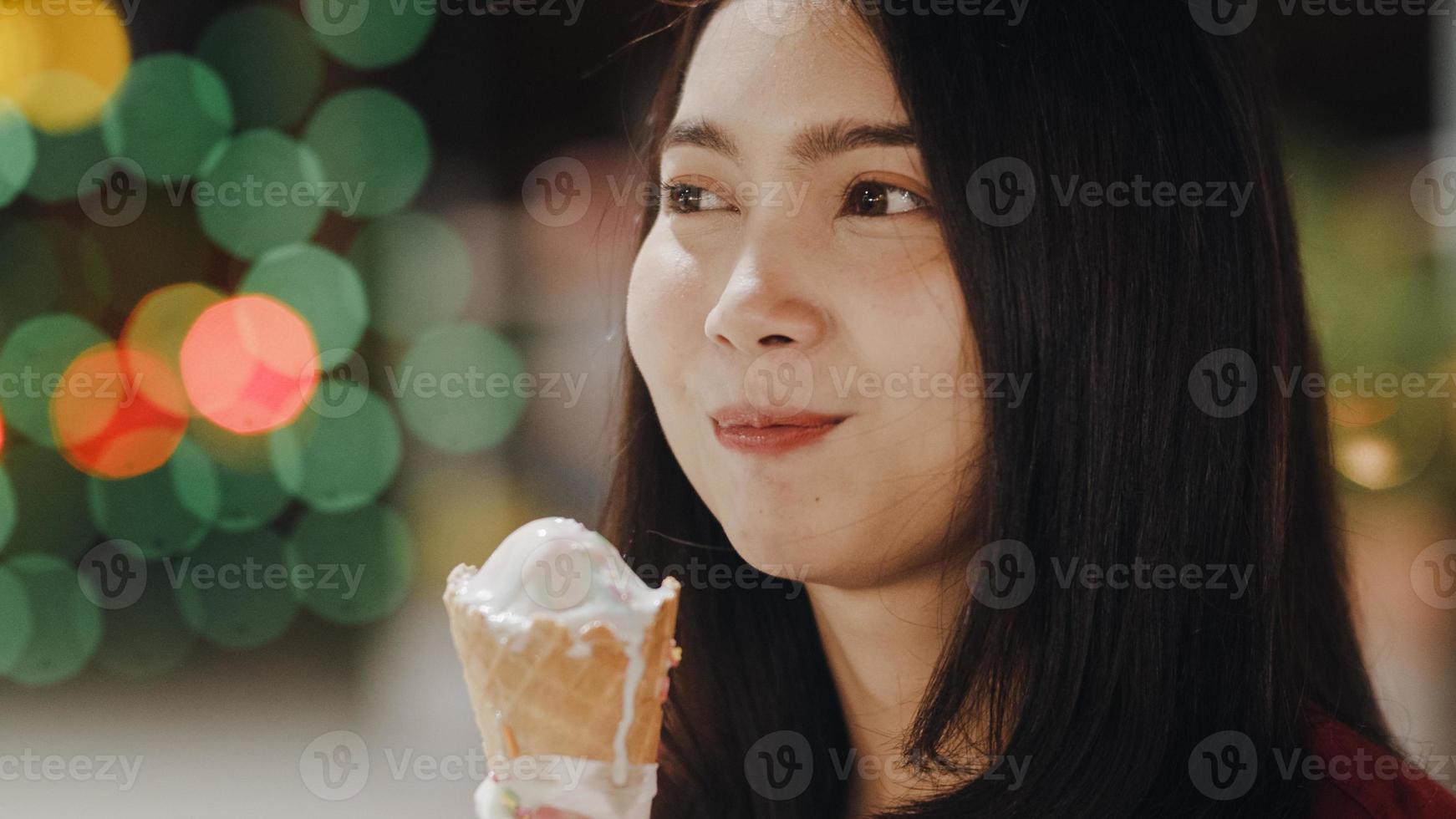 asiatische junge frau reist in bangkok, thailand, schöne weibliche gefühle, die glücklich gehen und eis essen an der khao san road. frauen reisen essen straßenessen im thailand-konzept. foto