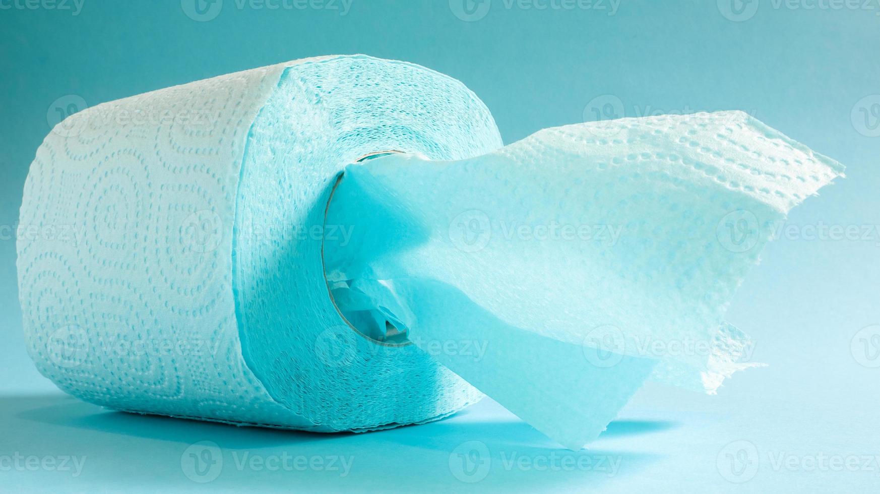 Blaue Rolle modernes Toilettenpapier auf blauem Hintergrund. ein Papierprodukt auf einer Papphülle für Hygienezwecke aus Zellulose mit Ausschnitten zum einfachen Aufreißen. geprägte Zeichnung foto