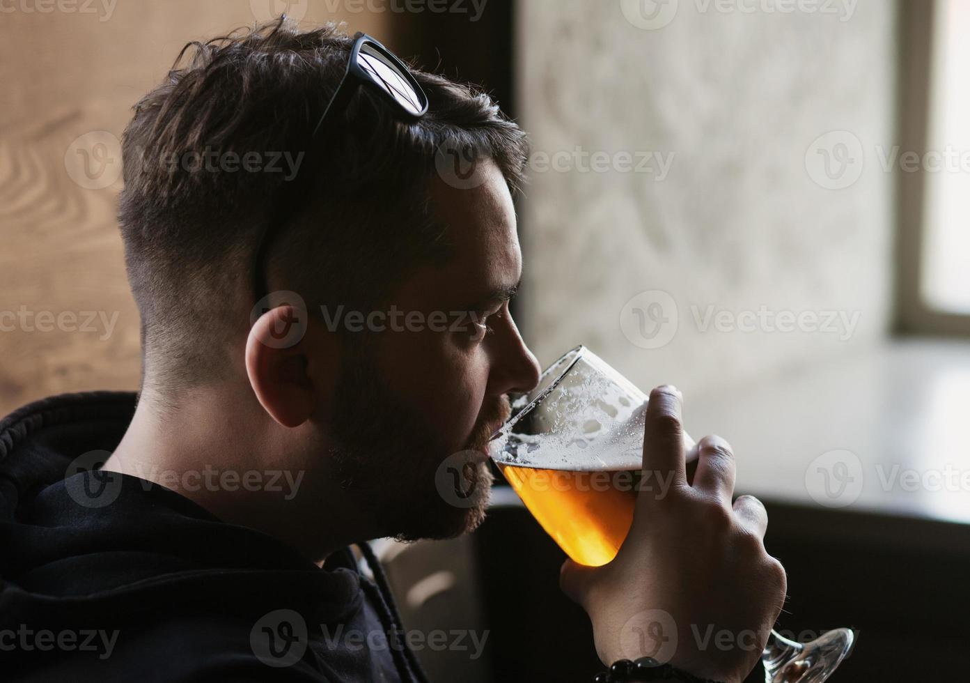 Schöner Mann trinkt Bier foto