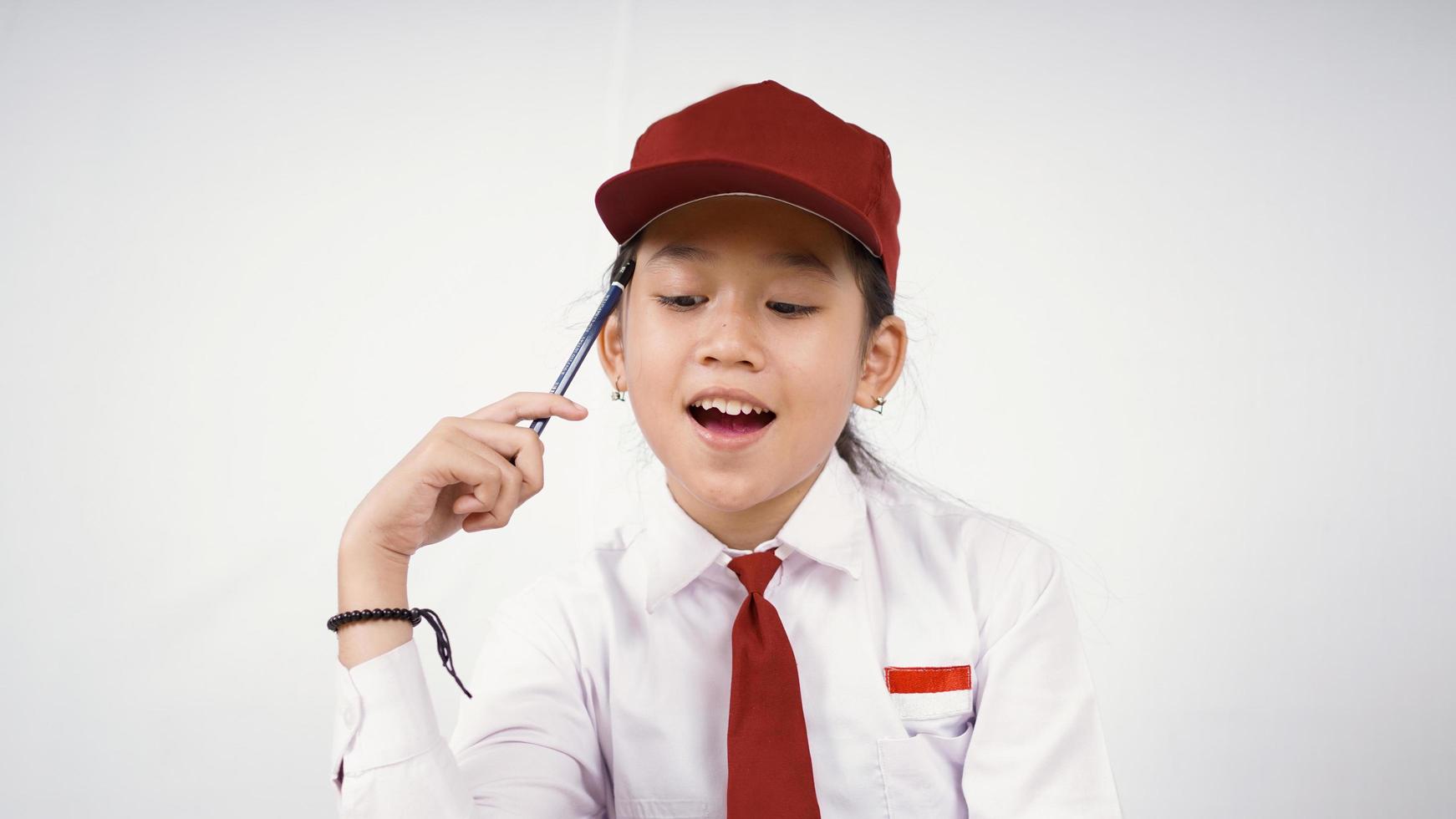 Grundschule asiatisches Mädchen findet interessante Idee isoliert auf weißem Hintergrund foto