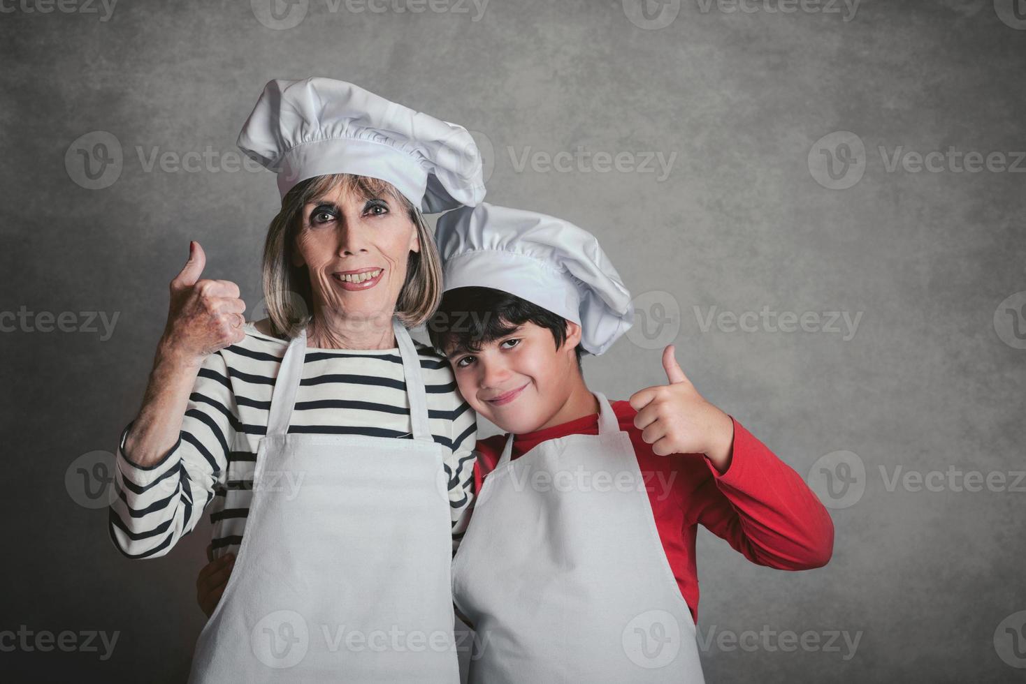 Großmutter und Enkel mit Kochmütze foto
