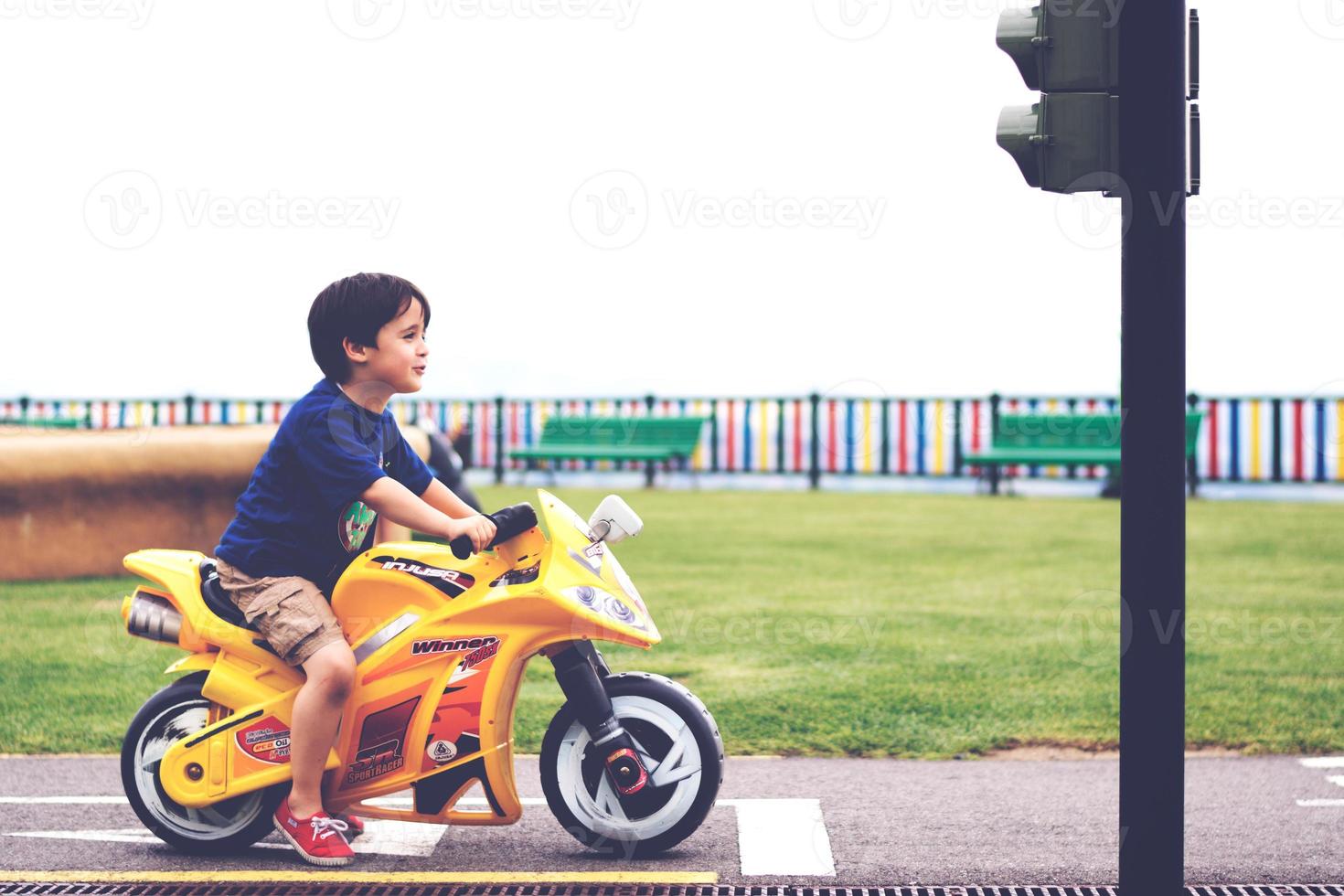 Junge spielt mit einem Motorrad foto