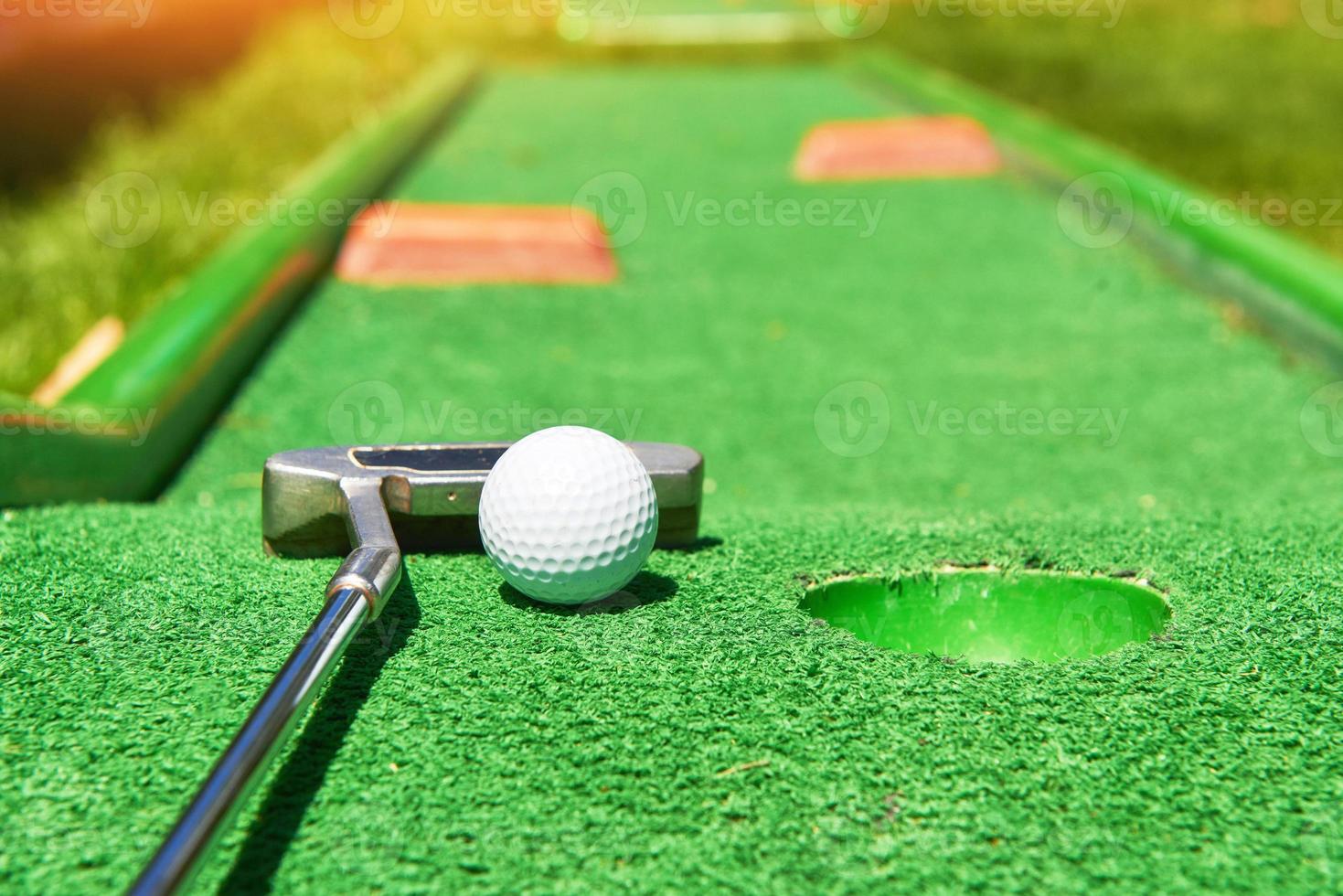 Golfball und Golfschläger auf Kunstrasen foto