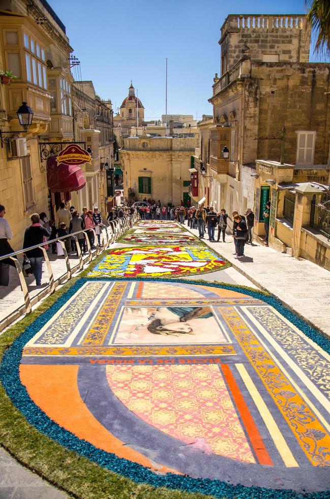 victoria, malta - 12. märz 2017 bunte mosaikblumen zeichnen teppich auf der straße in der nähe der alten mittelalterlichen cittadella turmburg, auch bekannt als zitadelle, castello in victoria rabat town, gozo island foto