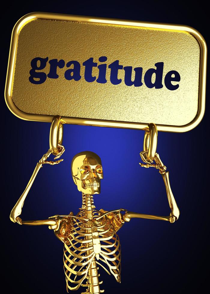 Dankbarkeitswort und goldenes Skelett foto