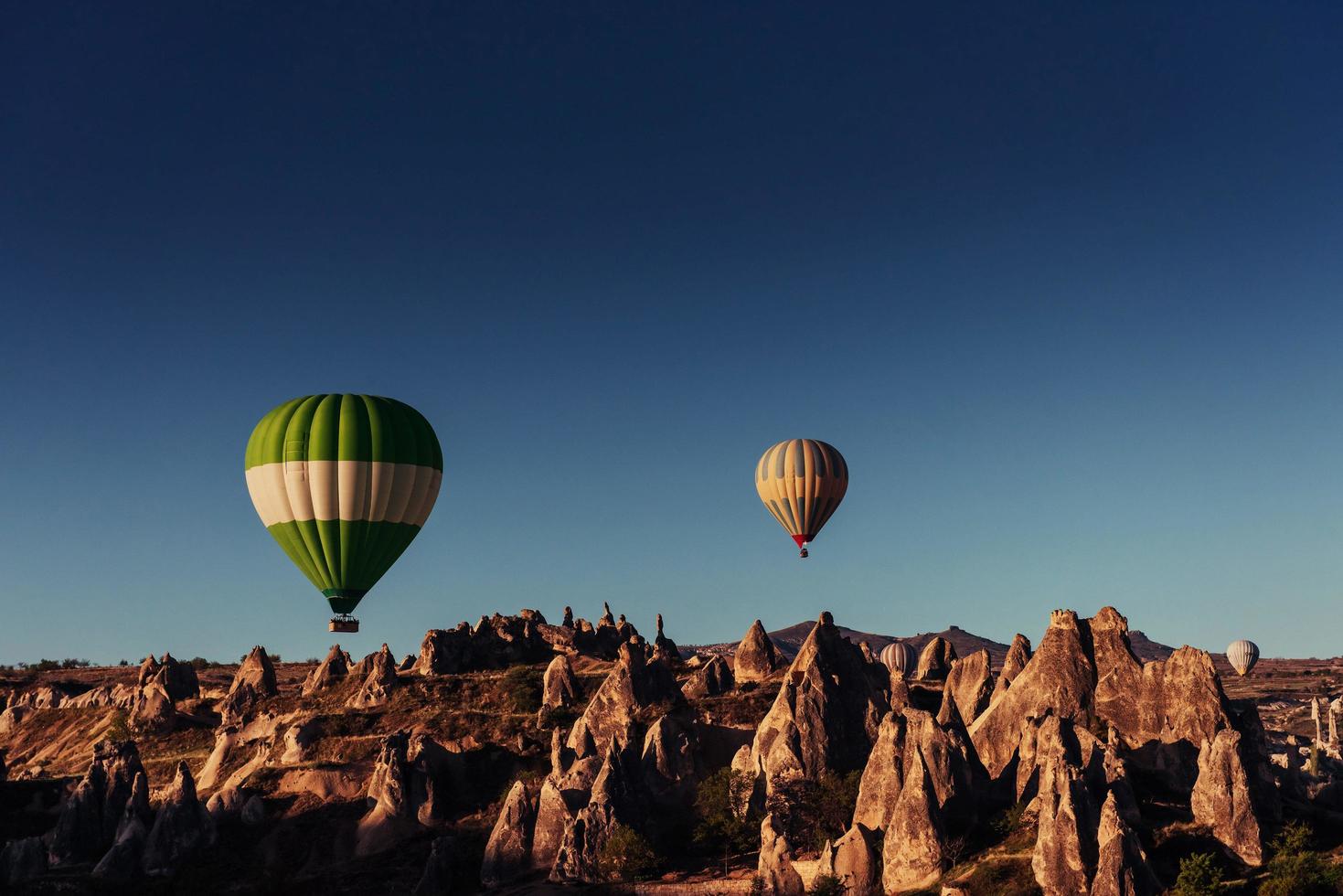 Heißluftballon, der über Felsenlandschaft am Kappadokien-Truthahn fliegt. foto