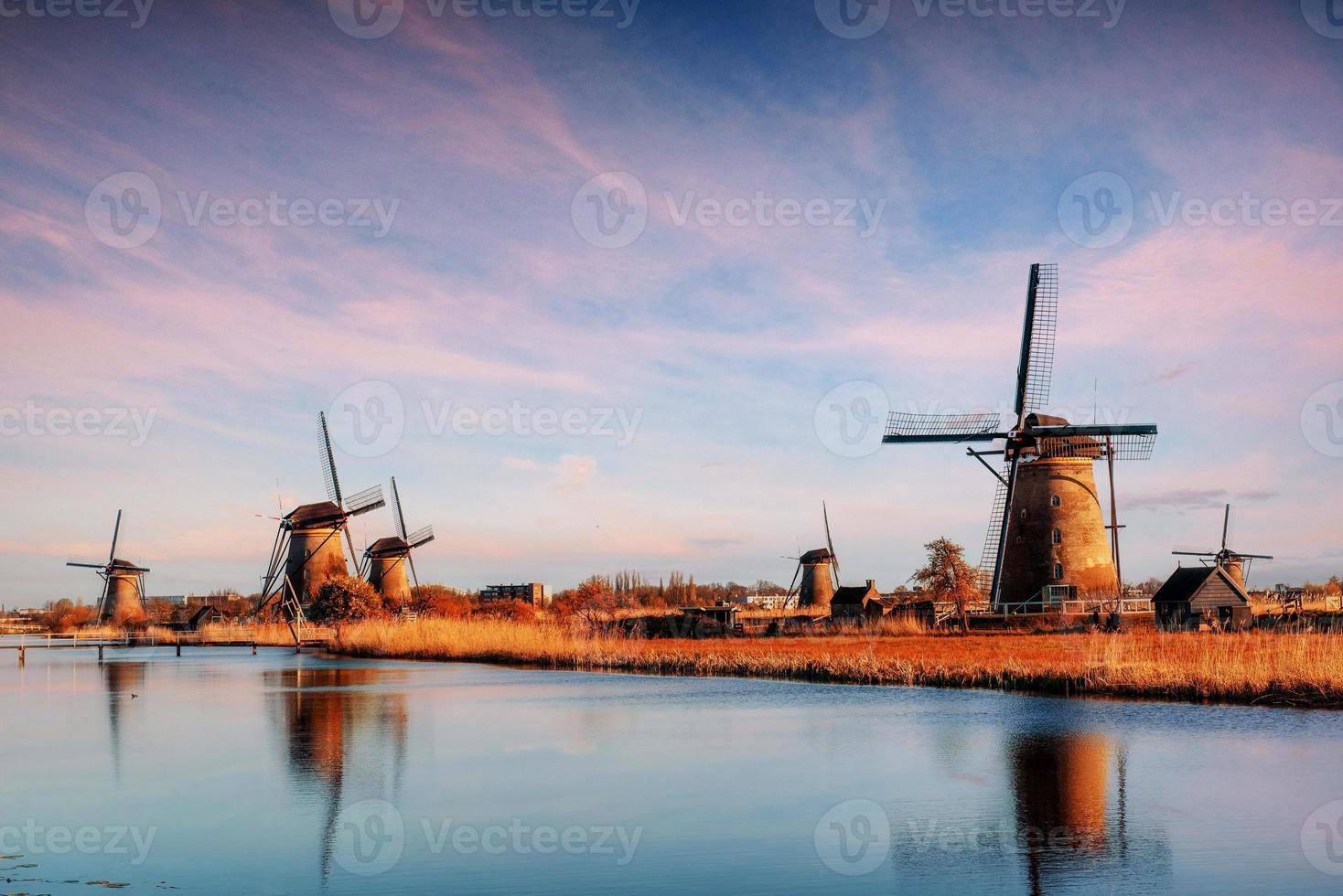 die straße, die vom kanal zu den holländischen windmühlen führt foto